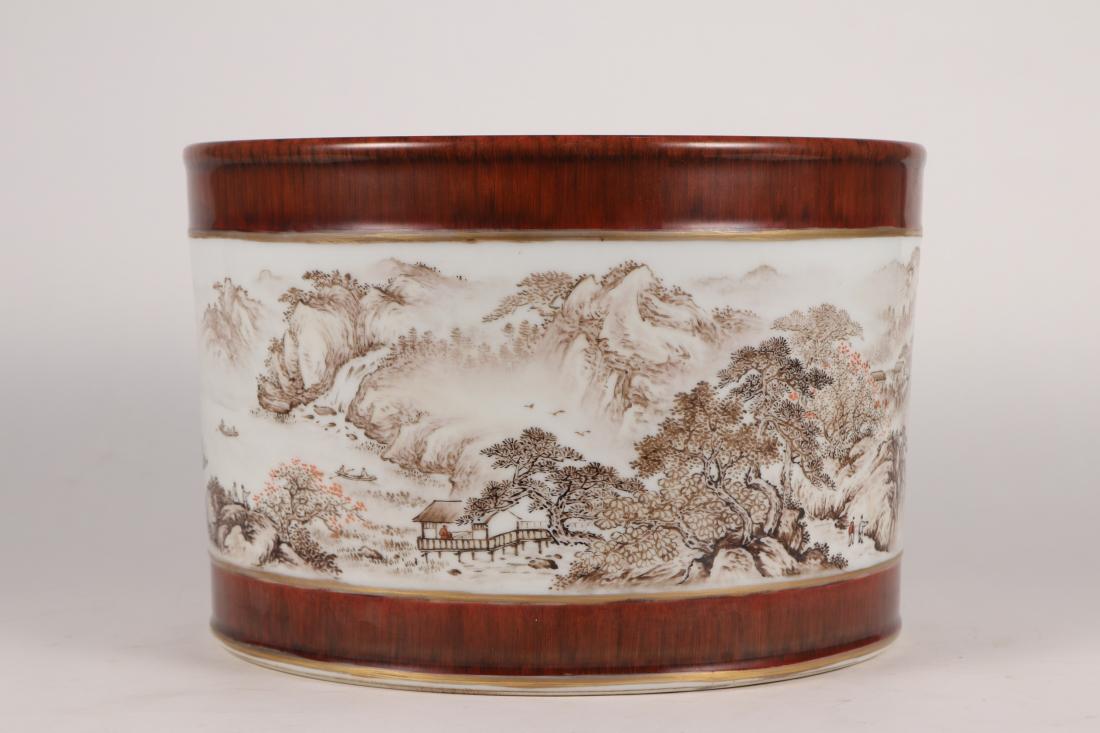 WHITE GROUND FAMILLE ROSE PORCELAIN BRUSH POT: White ground famille rose porcelain brush pot. There is a six-character "Da Qing Qian Long Nian Zhi" on the bottom. Dimensions: H 20.5 cm, Diam 31 cm. All measurements are approximate.
