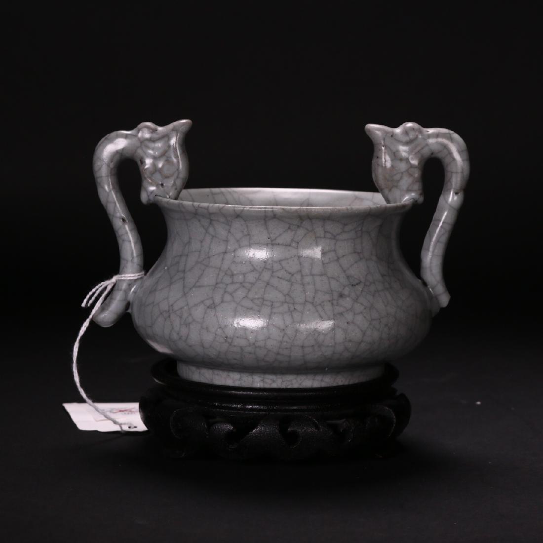 Bonhams Sale, A Song Dynasty Ge-Yao Censer: A censer of bombé form with loop handles in the form of dragon heads, the surfaces covered with a black-stained web of craze lines in the opaque gray glaze associated Guan ware.Provenance: Bonhams au