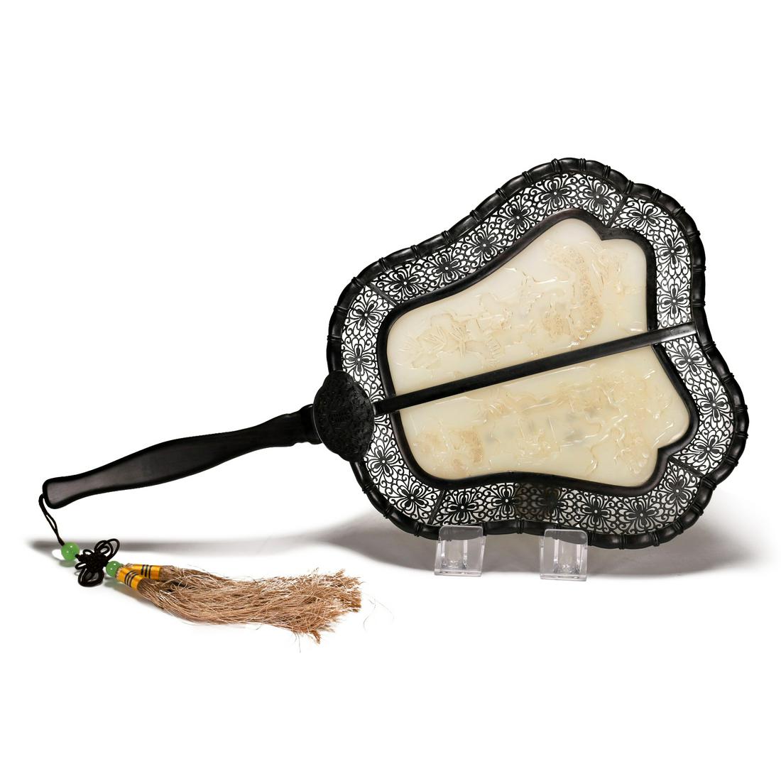 A White Jade Inlaid Carved Fan: A white jade inlaid carved fan plaque. Carved to one side with pines and the other side with Chinese calligraphy.