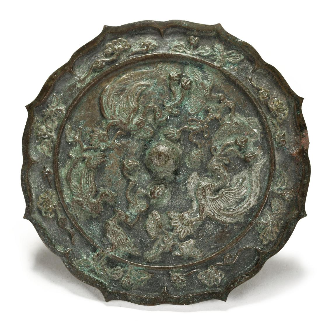 A Chinese Antique Bronze Mirror: A Chinese Antique Bronze Mirror. Possibly han dynasty. Size: Diameter: 7 1/2 inches.