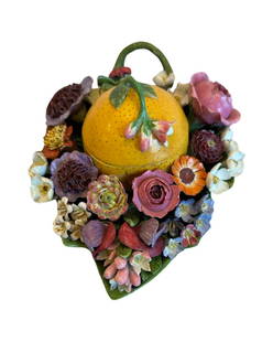 Rare Antique Meissen box in the shape of a lemon surrounded by a field of flowers: A lovely Meissen porcelain box. Executed in a trompe loeil fashion the piece showcases the mastery of porcelain handling for Meissen. The inkwell is shaped as a lemon surrounded by vibrant flowers res