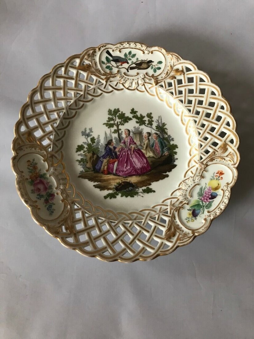 Meissen reticulated plate: ANTIQUE MEISSEN RETICULATED PLATELate 19th century, blue crossed swords marks, various impressed numeralsFinely painted after with amorous eighteenth century couple in rural landscapes within a gilt s