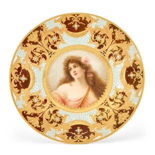 Antique Royal Vienna Plate Signed Wagner: Emblematic of Summer, artist signed Wagner, late 19th/early 20th centuryThe center depicting a young maiden with pink roses in her long brown hair, in reverie, continuing to a 'jeweled' and claret-gro