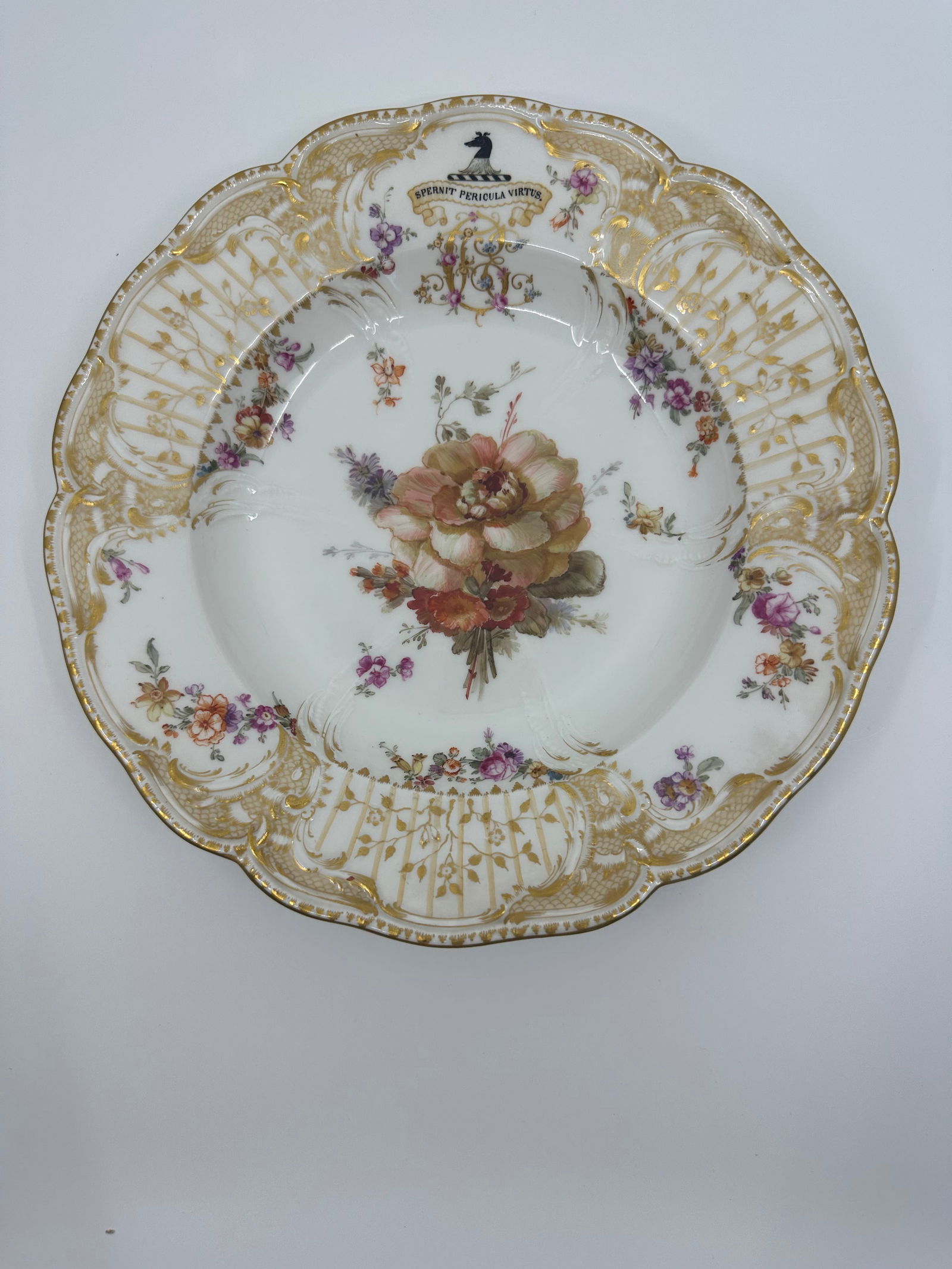 Antique KPM Floral Plate: Berlin (K.P.M) flower plateLate 19th century, blue sceptre, iron-red orb and KPM marks, impressed numeralsPainted with a spray of flowers, the well moulded and gilt with six foliate sprays, the border