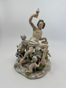 A Meissen group of Bacchus and attendants