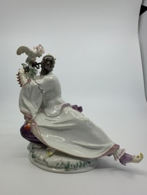 PORCELAIN FIGURE OF A MOOR WITH PARROT