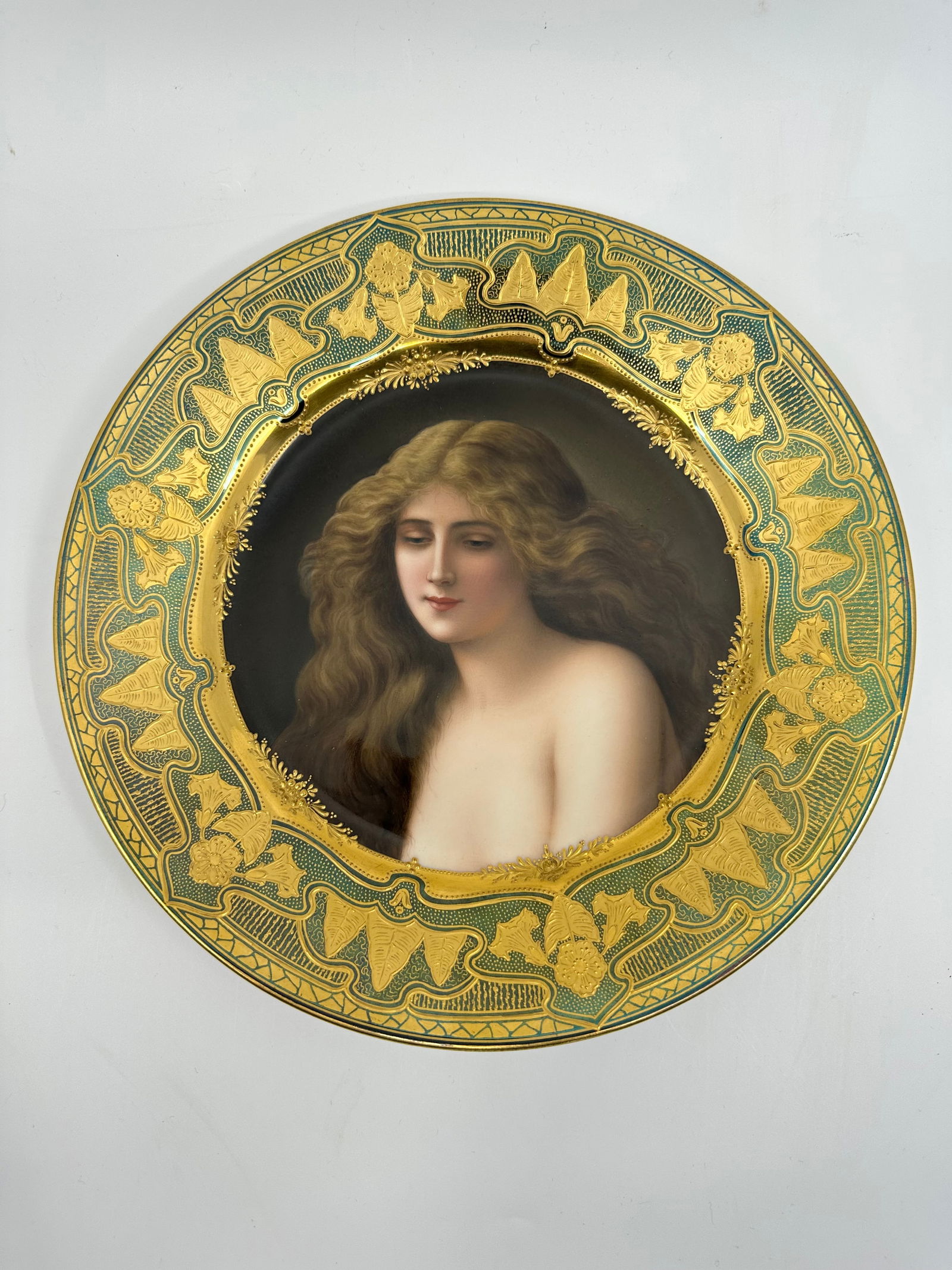 Royal Vienna Painted Porcelain Plate: Painted to depict a female beauty, with raised gilt decoration to the rim, with blue beehive mark and furthered labeled "Solitude. Depose". 9 3/4"D, circa early 20th century.