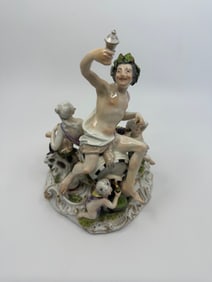 A Meissen group of Bacchus and attendants
