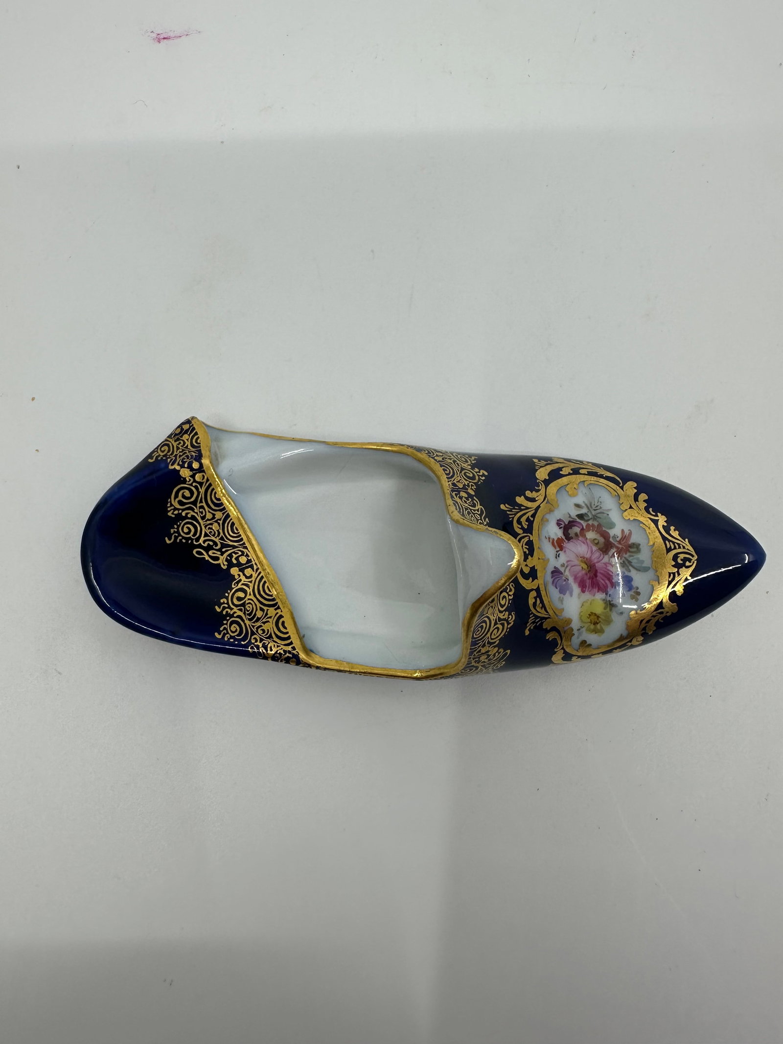 Antique meissen cobalt shoe: Meissen gilt blue shoe painted with flower. mark on bottom. 6 1/2"L x 2 1/2"W x 2 1/4"H