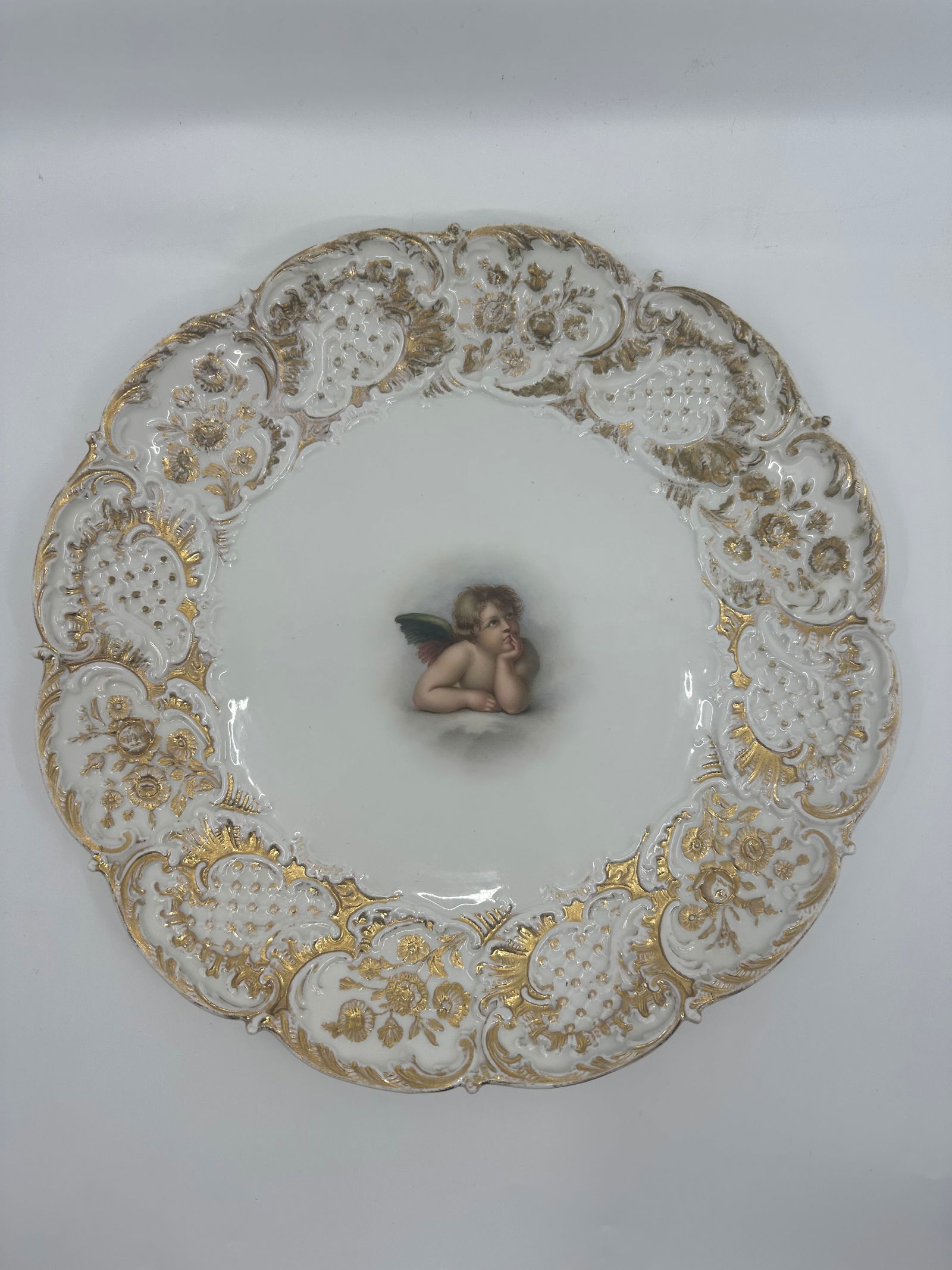 Antique Meissen cherub plate: Antique Meissen porcelain plate with hand-painted gold decoration and angel after Raphael. Ca. 1900. 11 1/4" D