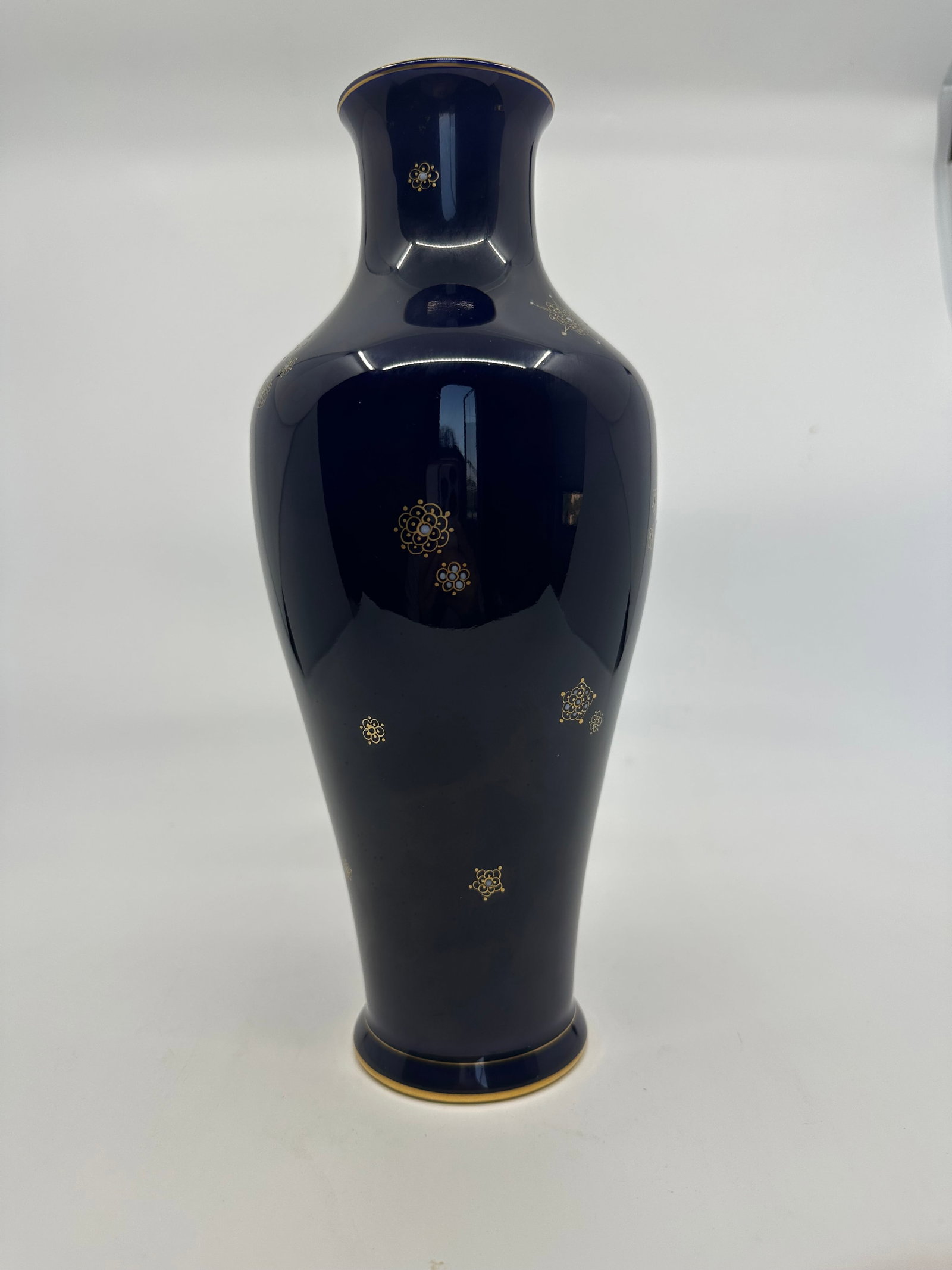 Dore Sevres porcelain vase of tapered ovoid form: R F Dore Sèvres porcelain vaseof tapered ovoid form, cobalt mottled blue, with gilt moth and clover decoration, gilt rim, green triangle 1920 mark and Dore 1920 mark to inner neck, 11in. high.