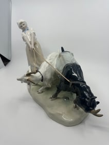 A Meissen porcelain group of a female goat keepers