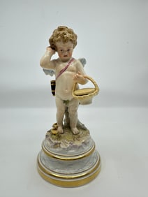 Antique meissen cupid carrying basket