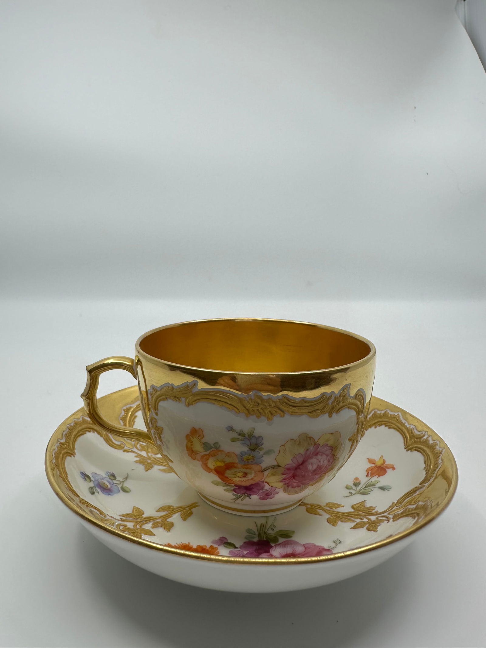 ANTIQUE KPM BERLIN GILT & HAND PAINTED FLORAL DEMITASSE CUP: SIGNED 19TH CENTURY KPM BERLIN GILT & HAND PAINTED FLORAL DEMITASSE CUP & SAUCERThe demitasse cup measures approximately 2 1/8" high by 4" in diameter. The saucer measures approximately 1 1/4" high by