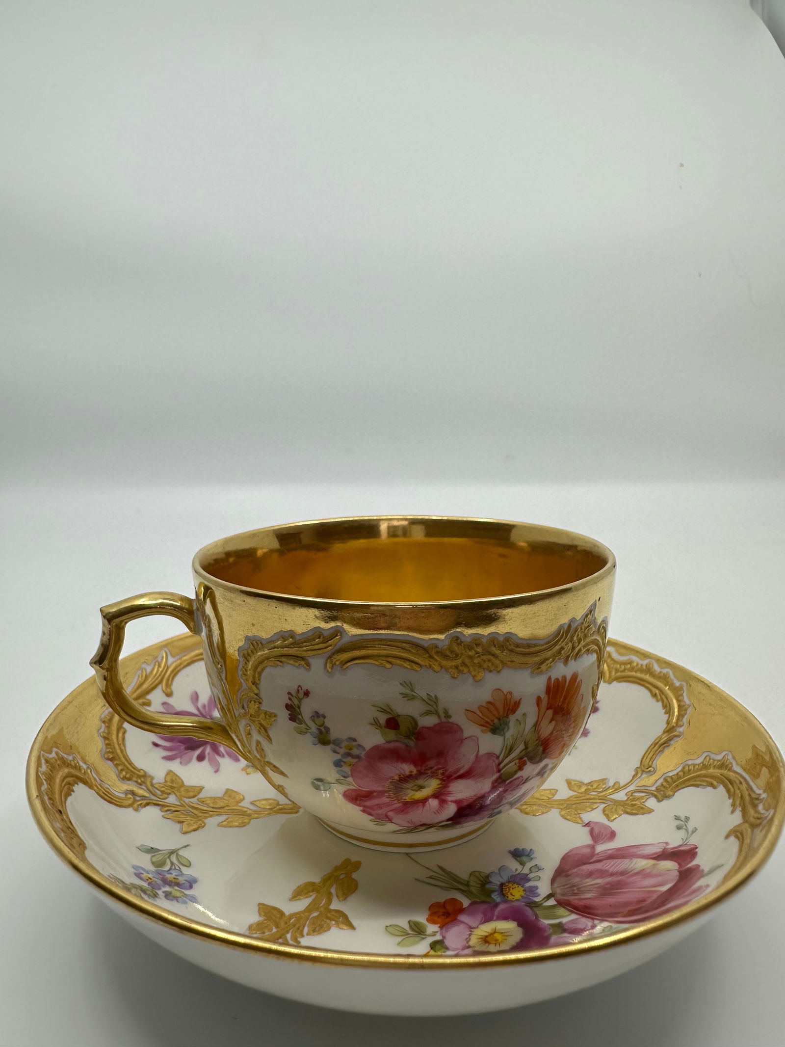 ANTIQUE KPM BERLIN GILT & HAND PAINTED FLORAL DEMITASSE CUP: SIGNED 19TH CENTURY KPM BERLIN GILT & HAND PAINTED FLORAL DEMITASSE CUP & SAUCERThe demitasse cup measures approximately 2 1/8" high by 4" in diameter. The saucer measures approximately 1 1/4" high by