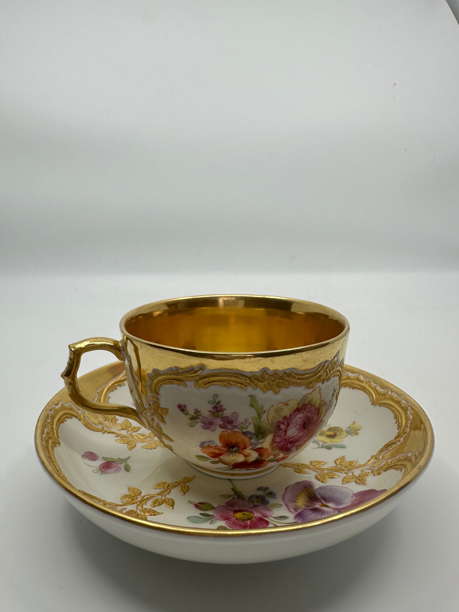 ANTIQUE KPM BERLIN GILT & HAND PAINTED FLORAL DEMITASSE CUP: SIGNED 19TH CENTURY KPM BERLIN GILT & HAND PAINTED FLORAL DEMITASSE CUP & SAUCERThe demitasse cup measures approximately 2 1/8" high by 4" in diameter. The saucer measures approximately 1 1/4" high by