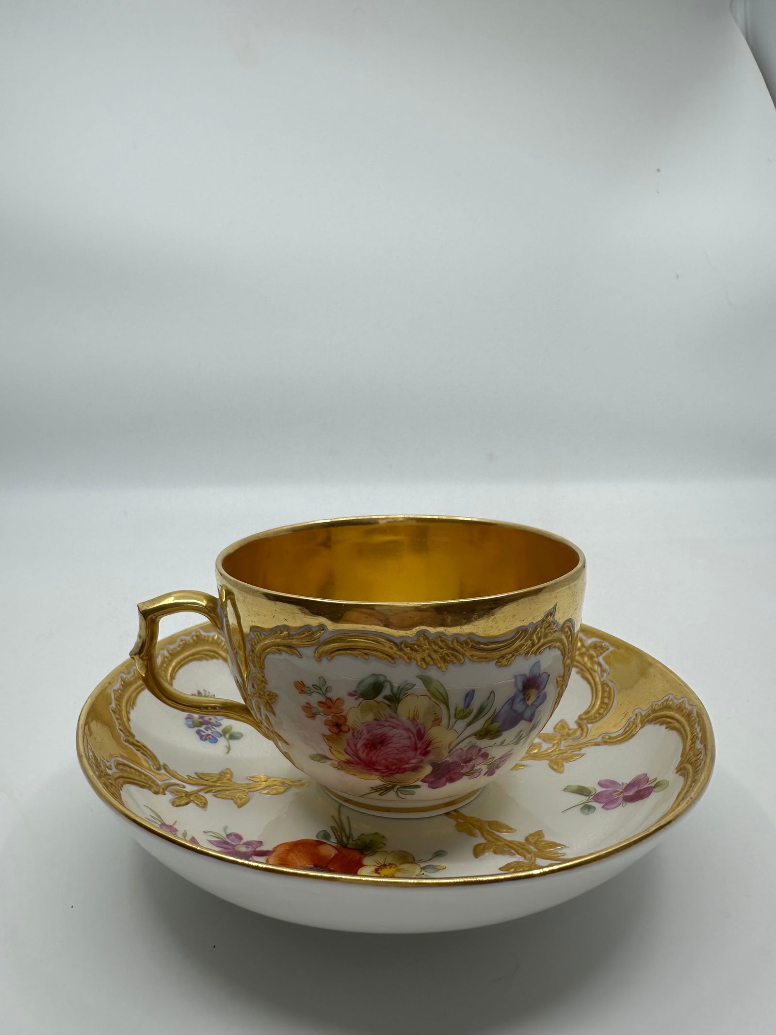 ANTIQUE KPM BERLIN GILT & HAND PAINTED FLORAL DEMITASSE CUP: SIGNED 19TH CENTURY KPM BERLIN GILT & HAND PAINTED FLORAL DEMITASSE CUP & SAUCERThe demitasse cup measures approximately 2 1/8" high by 4" in diameter. The saucer measures approximately 1 1/4" high by