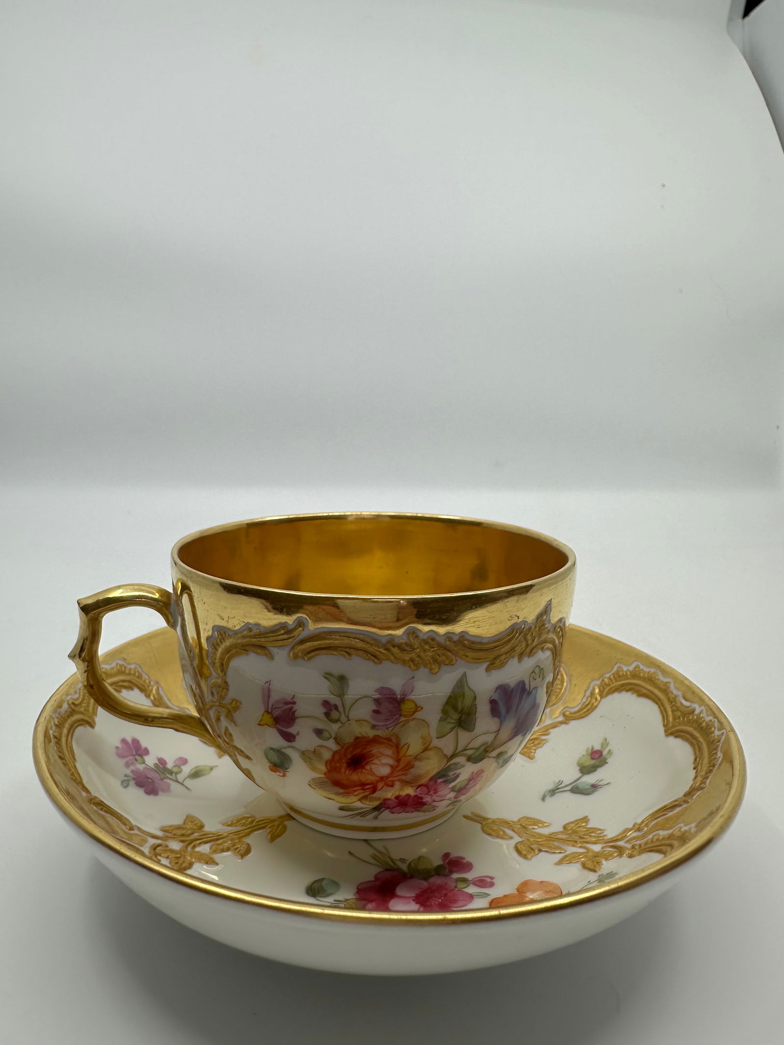 ANTIQUE KPM BERLIN GILT & HAND PAINTED FLORAL DEMITASSE CUP: SIGNED 19TH CENTURY KPM BERLIN GILT & HAND PAINTED FLORAL DEMITASSE CUP & SAUCERThe demitasse cup measures approximately 2 1/8" high by 4" in diameter. The saucer measures approximately 1 1/4" high by