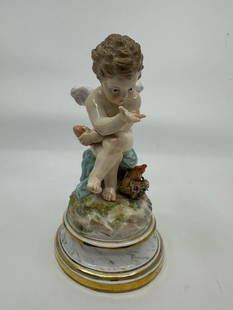 Antique Meissen Cupid Porcelain Figurine L103: DESCRIPTION: Antique Meissen polychrome enameled porcelain figurine (L103) depicting a cupid philosopher seated holding a heart in hand. Crossed swords hallmark at the underside and impressed "L103 14