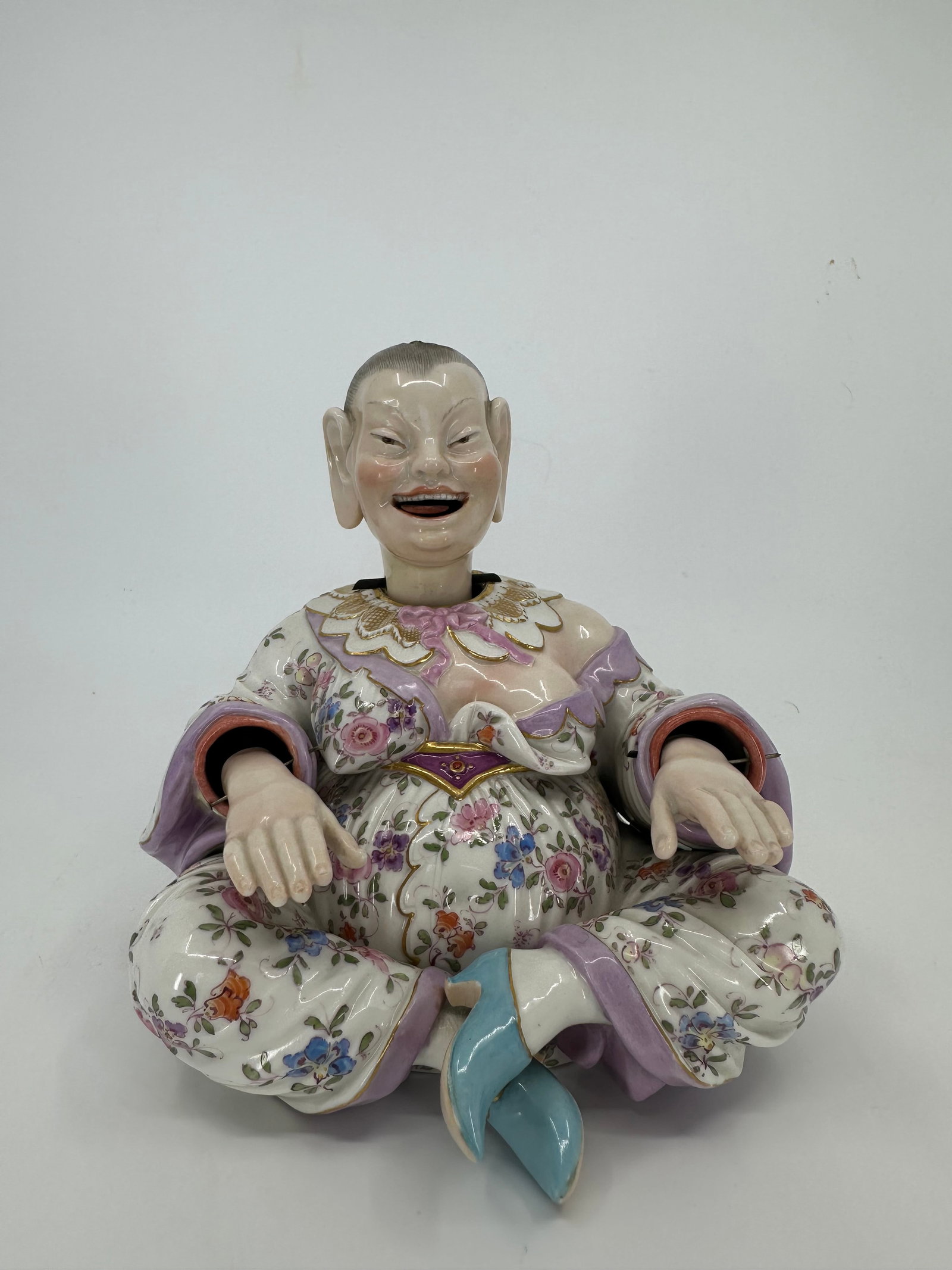 ANTIQUE MEISSEN PORCELAIN NODDING PAGODA FIGURE: LATE 19TH CENTURY, BLUE CROSSED SWORDS MARK, INCISED MODEL NO. Modeled seated with legs crossed, his mouth open in a smile revealing a wagging tongue, the detachable head with a lead counter-balance,
