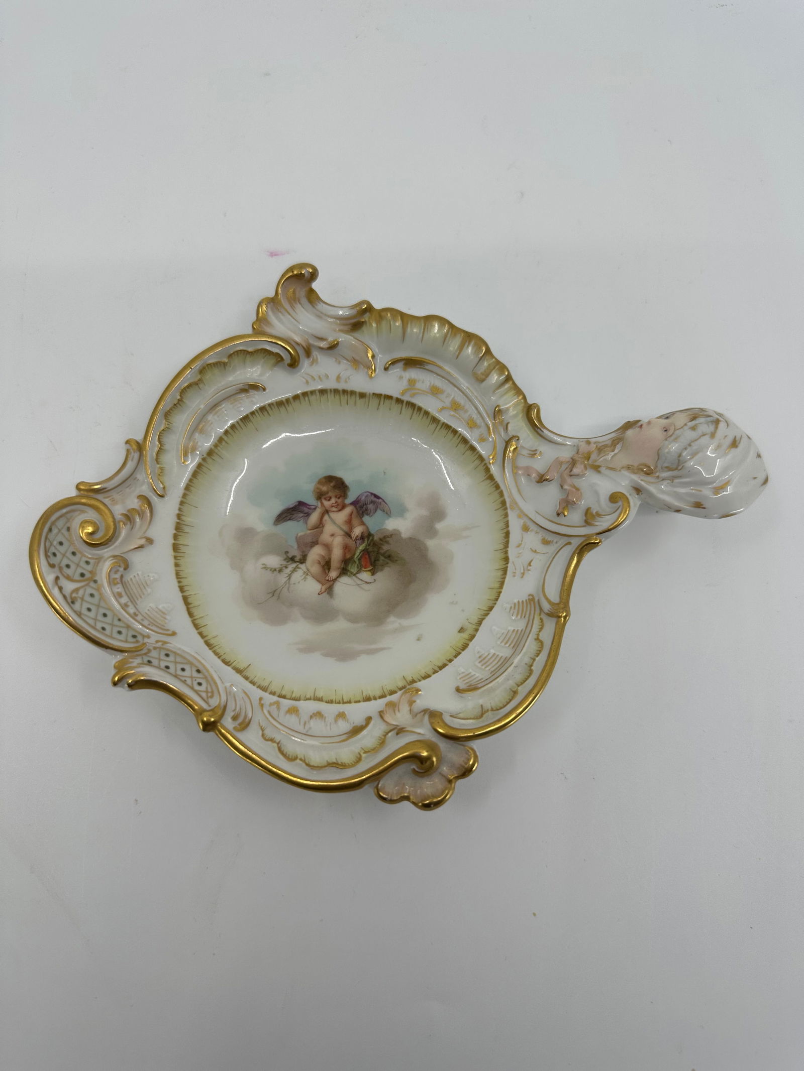 Antique KPM Porcelain Cupid Tray: Antique KPM Royal Berlin Porcelain tray with a Maiden's Head Handle. This exquisite piece features a delicate porcelain design with a unique handle in the shape of a maiden's head, Measures approximat