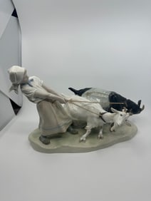 A Meissen porcelain group of a female goat keepers