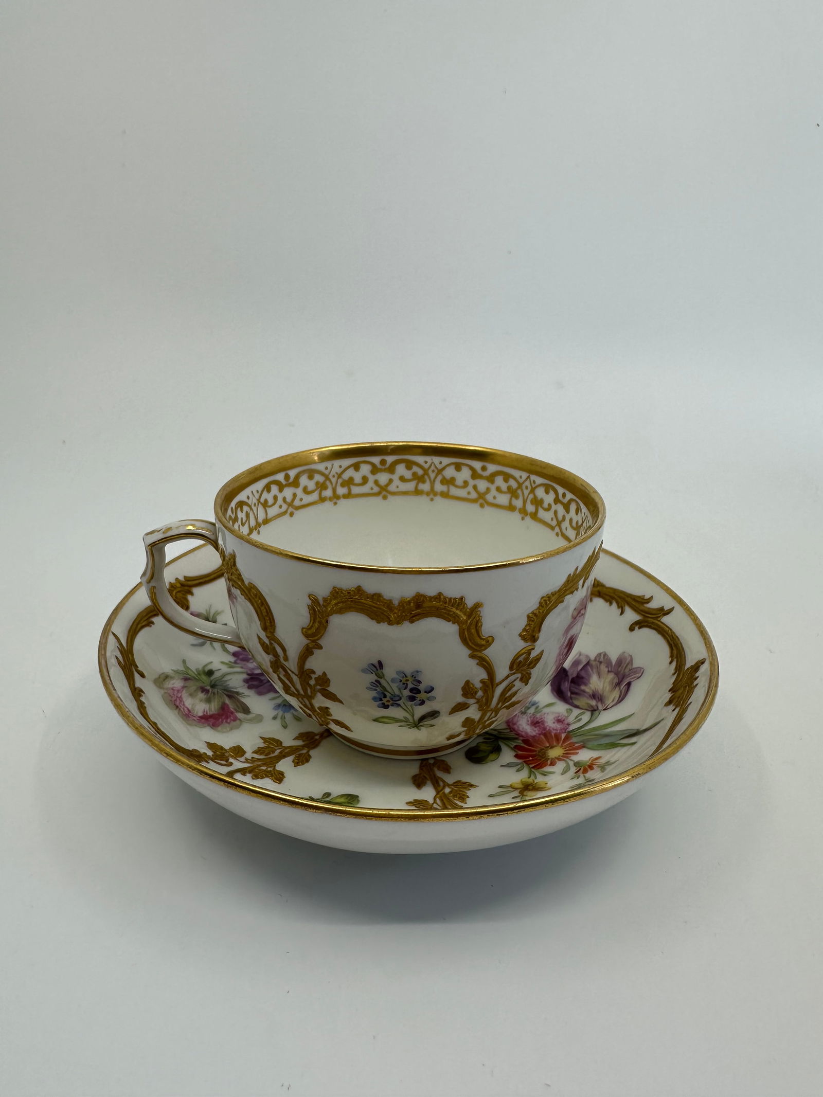 ANTIQUE KPM BERLIN GILT & HAND PAINTED FLORAL DEMITASSE CUP: SIGNED 19TH CENTURY KPM BERLIN GILT & HAND PAINTED FLORAL DEMITASSE CUP & SAUCERThe demitasse cup measures approximately 2 1/8" high by 4" in diameter. The saucer measures approximately 1 1/4" high by