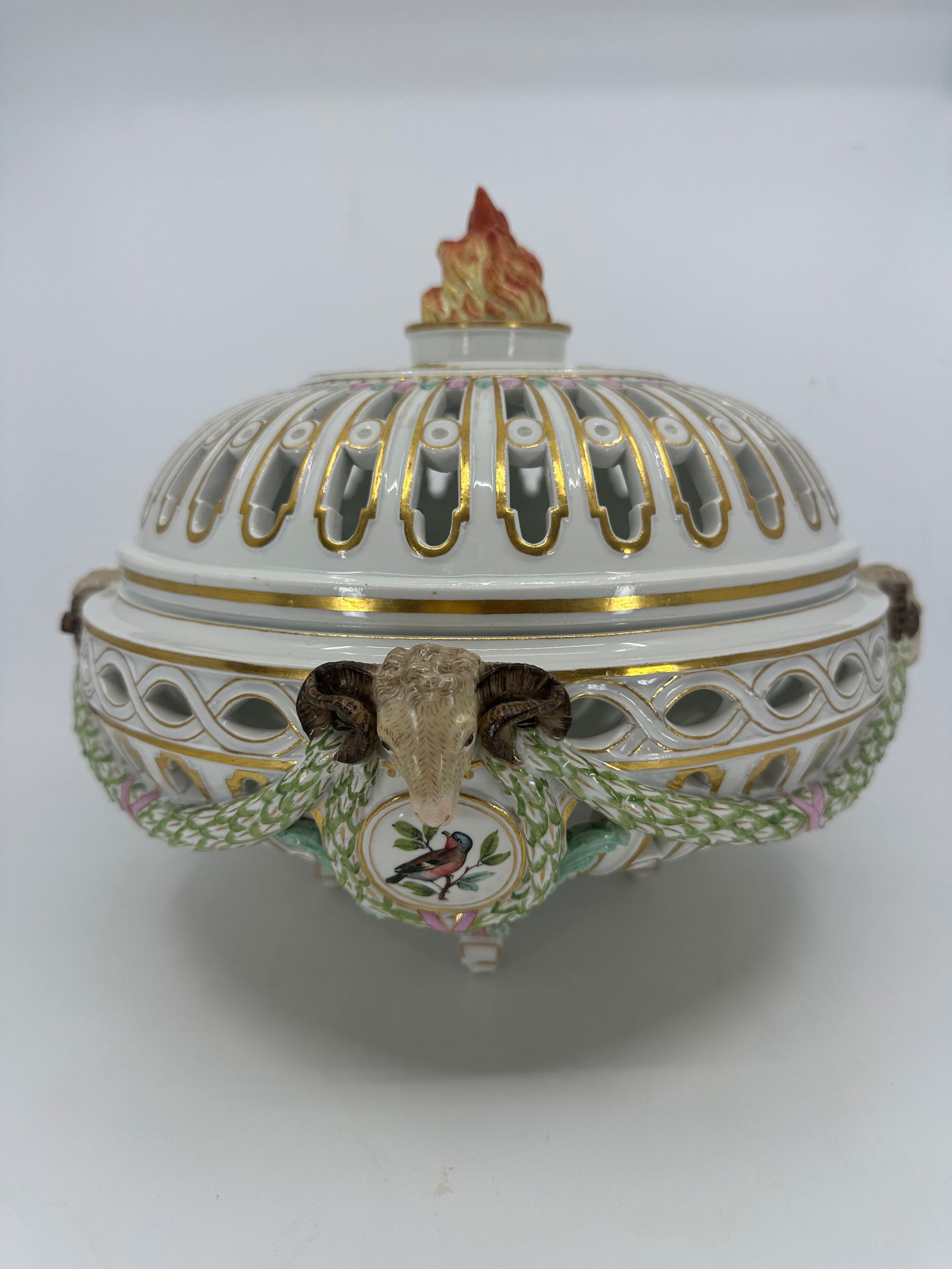 Rare Neoclassical Meissen Porcelain Reticulated Centerpiece with Rams Heads: A large, beautiful, and rare 19th century neoclassical reticulated Meissen centerpiece with open filigree, rams heads, flaming finial, and love bird cartouches. This exquisite Meissen centerpiece was