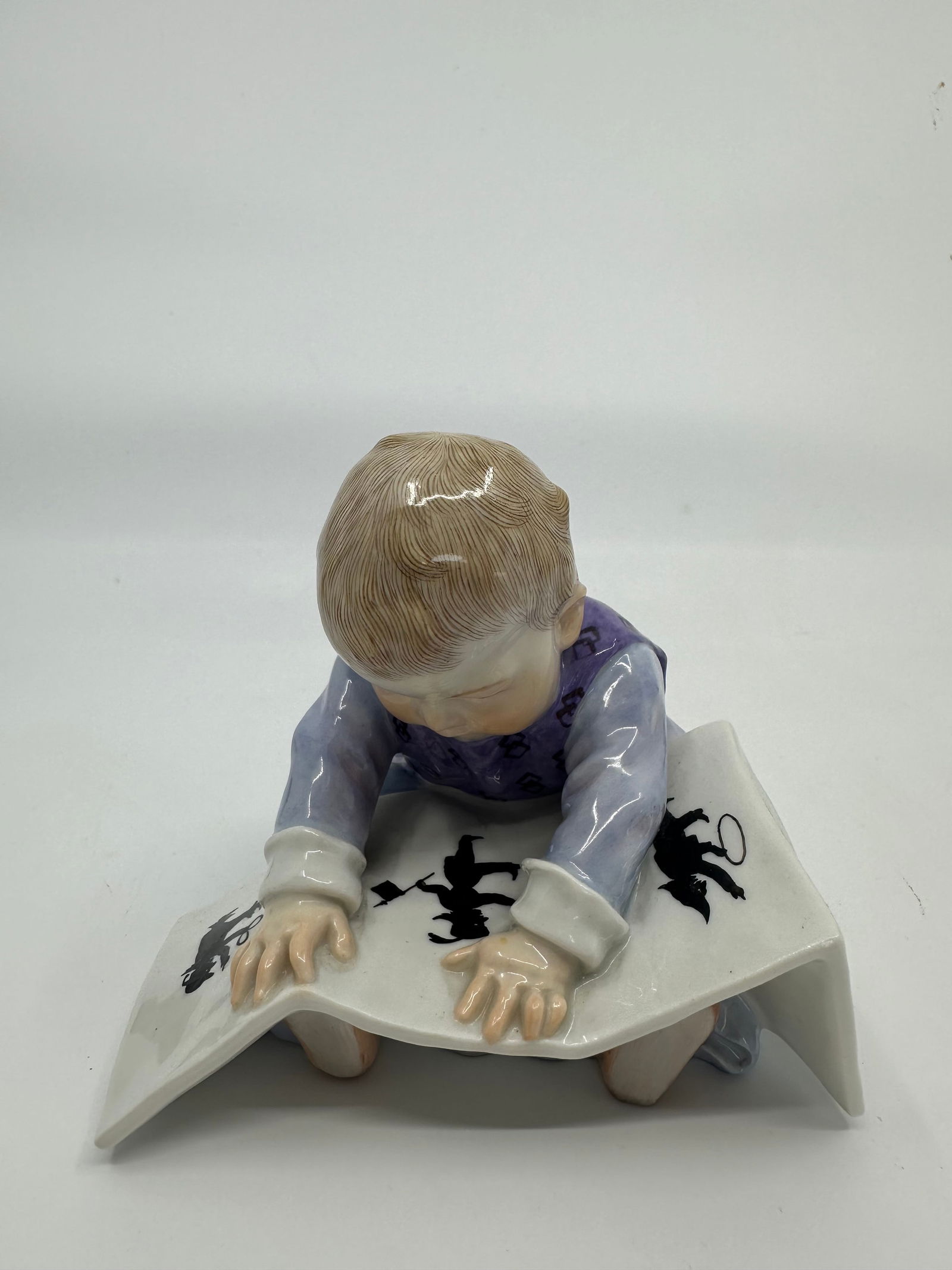 Meissen Porcelain Figure, Konrad Hentschel: Boy sitting with book. Crossed swords in underglaze blue, incised U149, impressed 6.4" H. Excellent condition, no chips or cracks