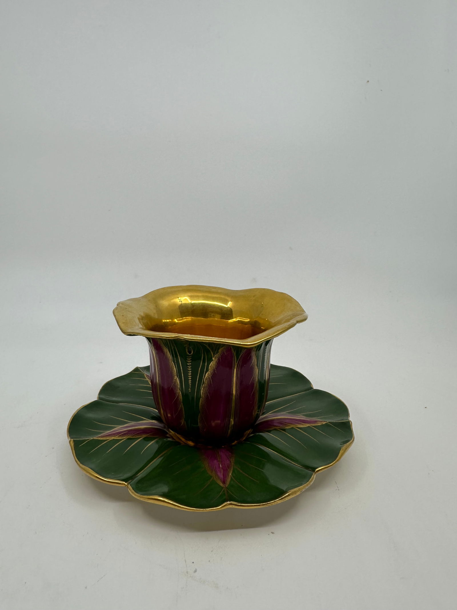 IMPORTANT ANTIQUE SEVRES CUPS AND SAUCERS (TASSE 'COBEA' ET SON SOUCOUPE): The cup and saucer formed as bell-shape cobaea blossom, painted in purple and green and enriched in gilt, the underside with blue stencilled interlaced Ls enclosing Sevres fleur-de-lys mark, the sauce