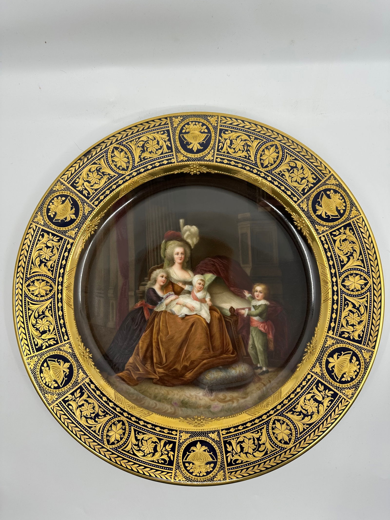Rare Antique Royal Vienna Porcelain Charger: Antique Large Size Royal Vienna Portrait Plate, entitled 'Antoinette et Famille', with gold border, center painting of Marie Antoinette with children. 12-1/2" diameter, with blue beehive mark, "Antoin