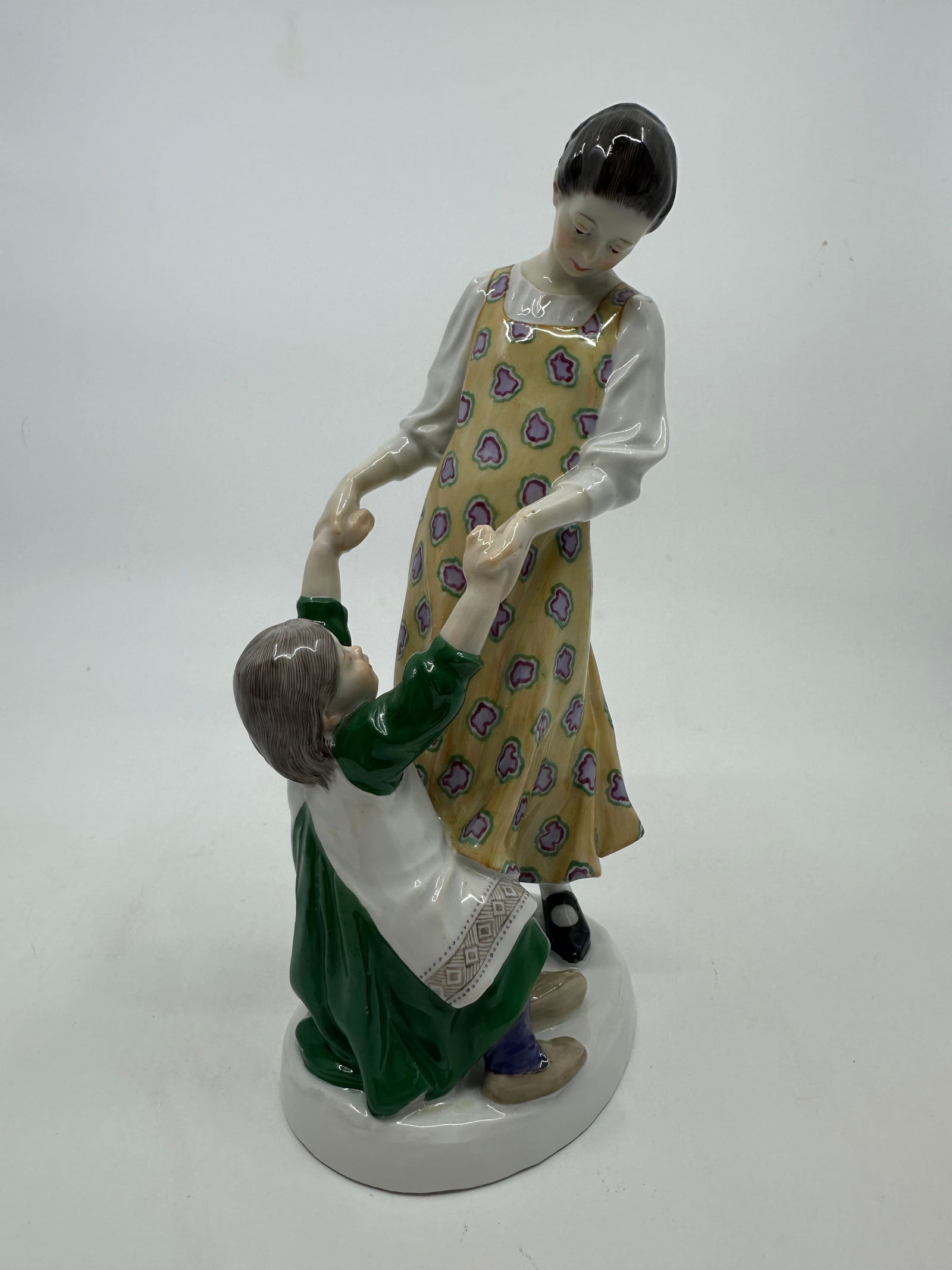 Meissen Art Nouveau Group of Sisters by Alfred Koenig, c.1905: Compassionately modelled with the older sister helping up the younger one after a tumble.The decoration is a rare combination of high-temperature underglaze and final firing overglaze techniques, whic