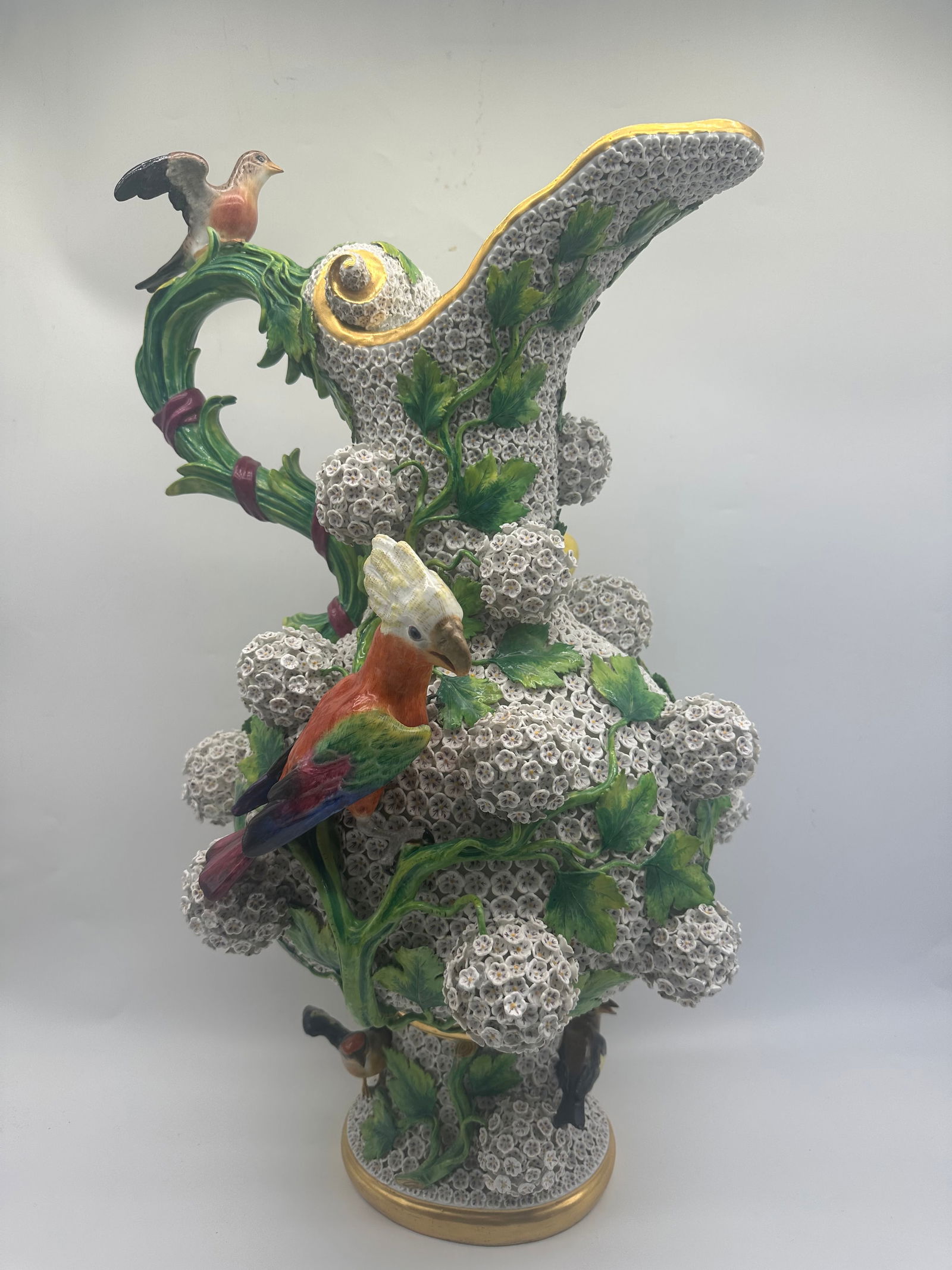 A MEISSEN LARGE 'SCHNEEBALLEN' EWER, LATE 19TH CENTURY: A MEISSEN LARGE 'SCHNEEBALLEN' EWER, LATE 19TH CENTURY the blossom-encrusted body applied with 18 balls of mayflower blossoms and spreading leafy vines, one side with affixed with a figure of a perchi