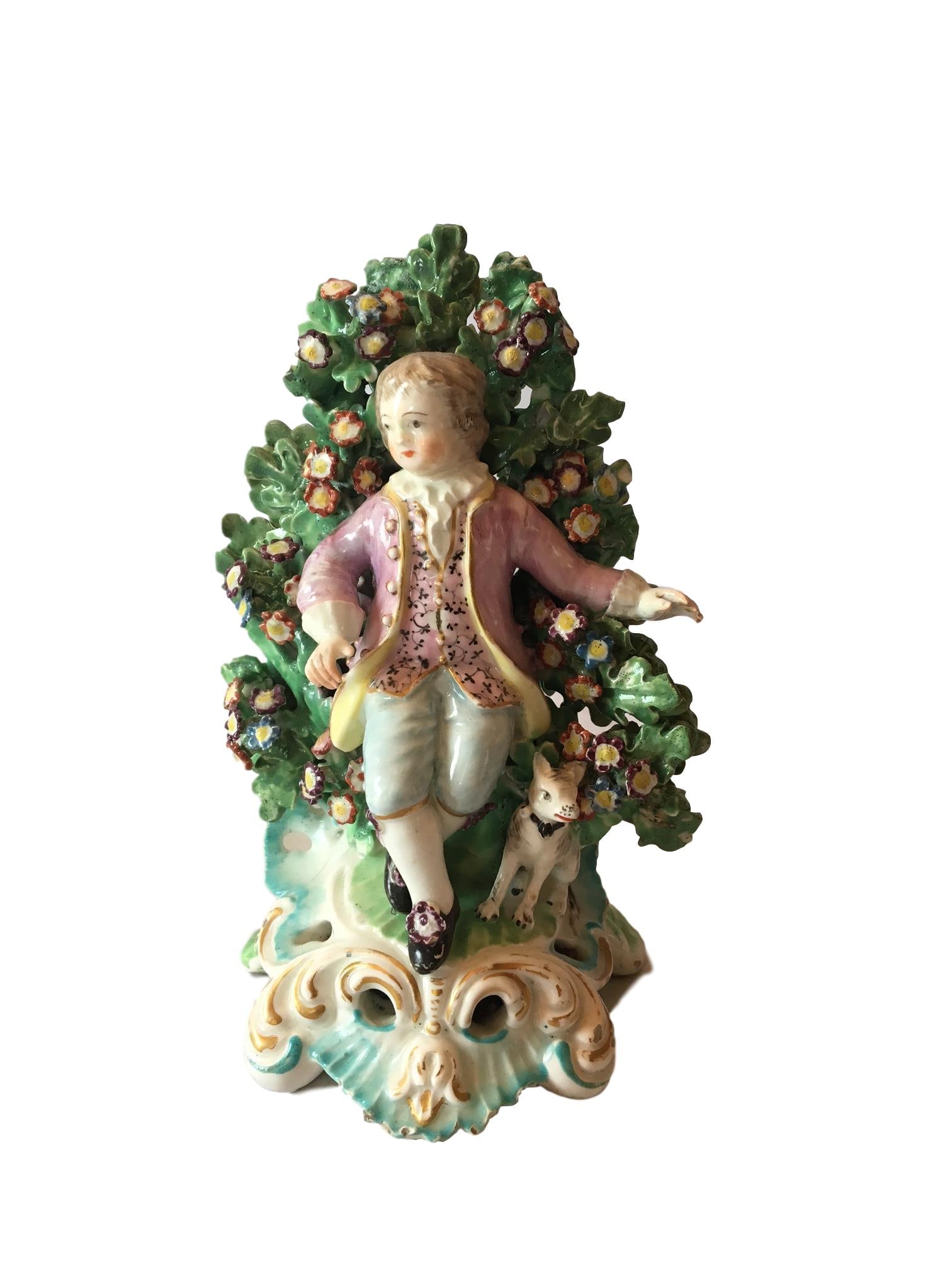 Antique Derby bocage figure of a seated boy: An 18th Century , Derby bocage figure of a seated boy and his dog on a gilt and blue rococo base, marks to base Height 6 1/4"