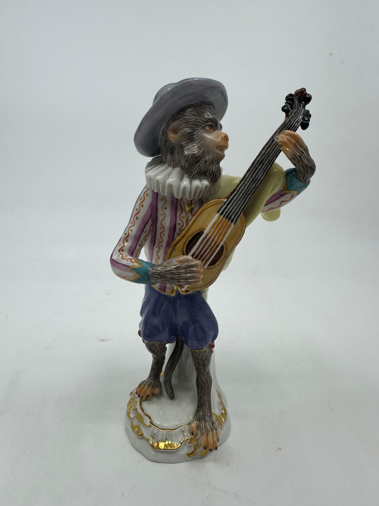 Meissen porcelain monkey band figure: Meissen porcelain monkey band figure. 19th century. scroll molded base with gilt edges. Blue crossed swords mark under glaze on base. Guitarist: 5.5" x 2 3/4".Condition Excellent condition, no chips o