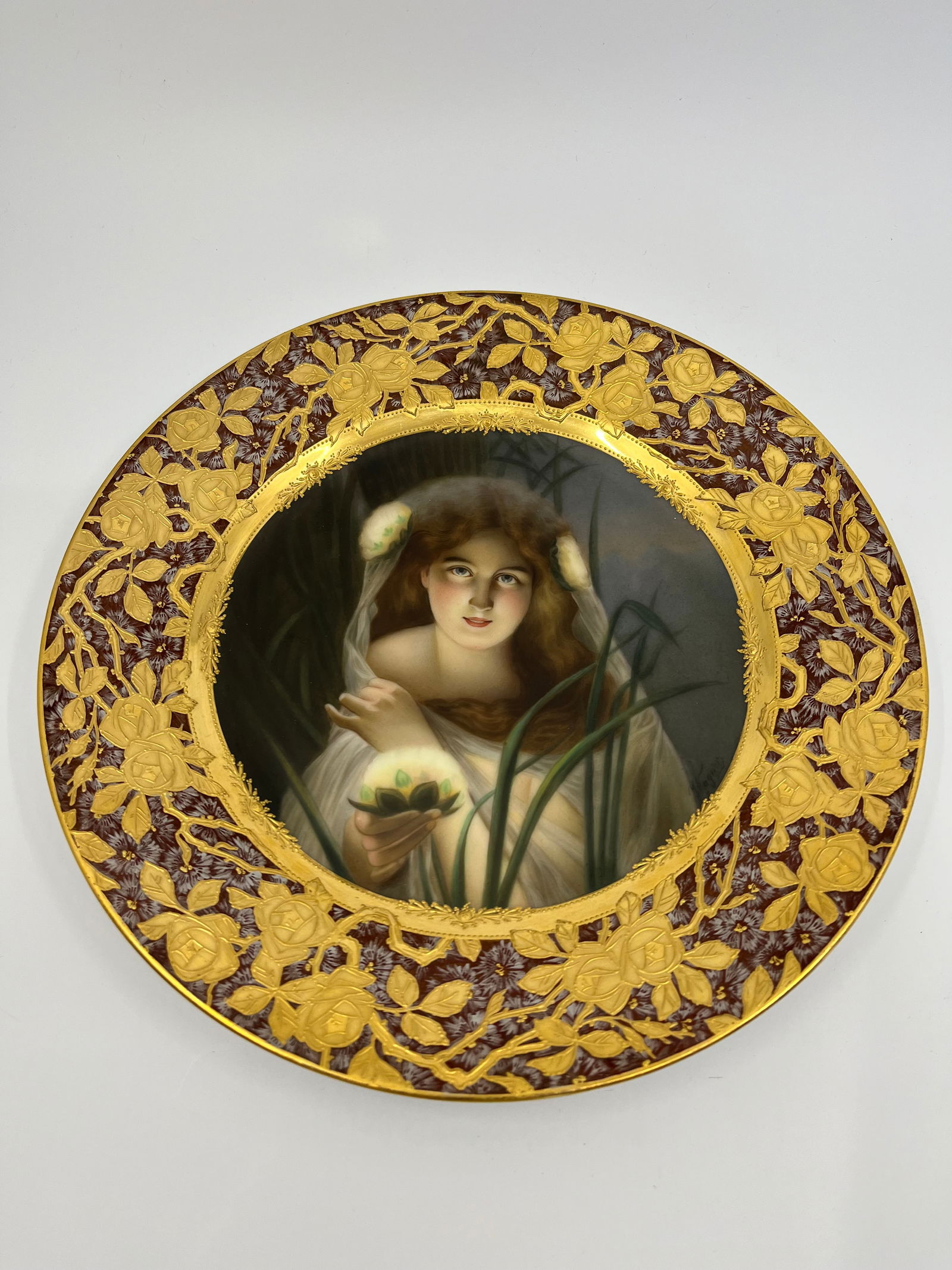 ANTIQUE ROYAL VIENNA HAND PAINTED PORTRAIT PLATE: ANTIQUE ROYAL VIENNA HAND PAINTED PORTRAIT PLATE Late 19th Century, underglaze Beehive mark and impressed Hutschenreuther maker's mark Titled Irlicht and signed Wagner Finely painted portrait, on a ra