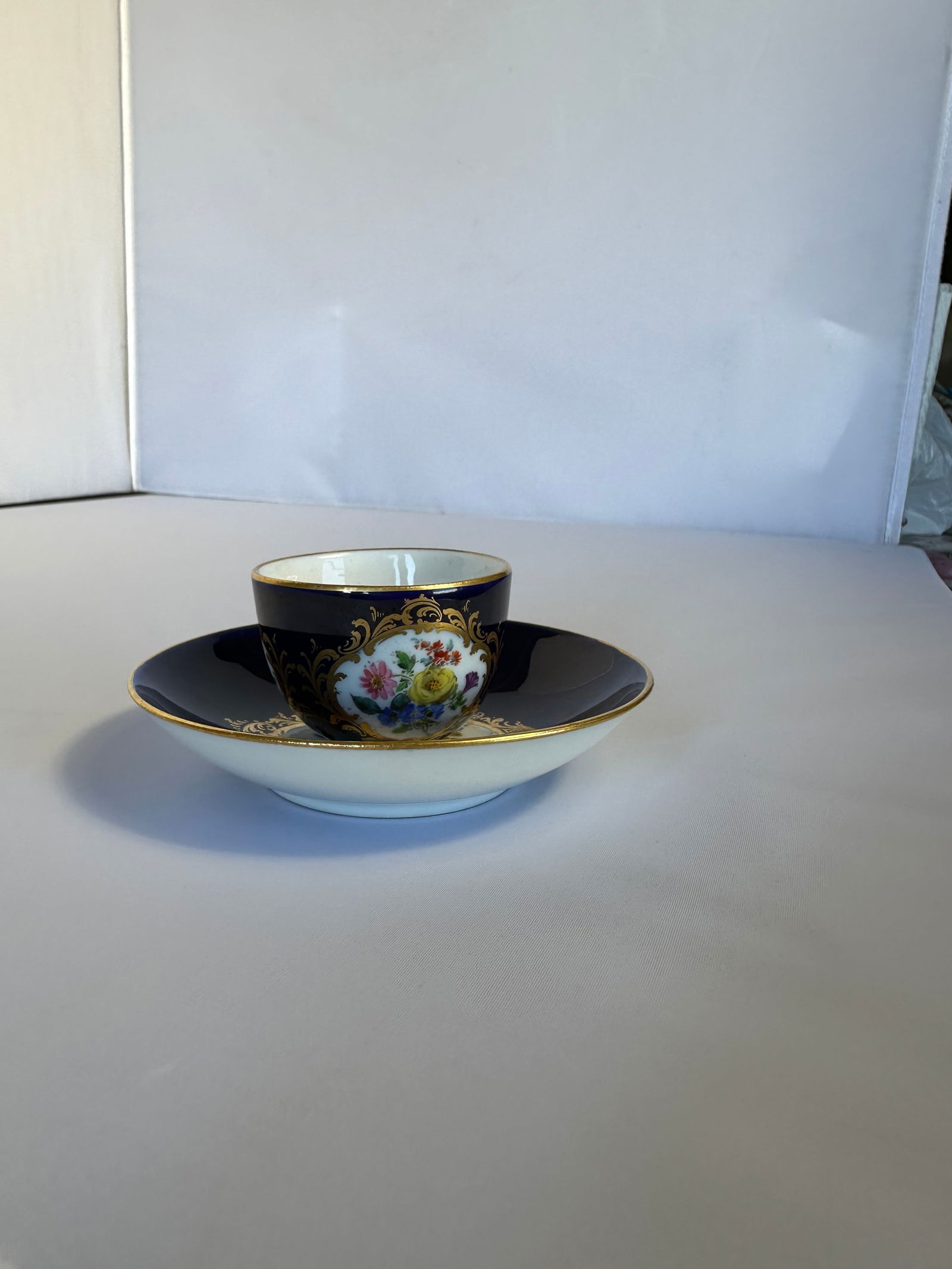 ANTIQUE MEISSEN PORCELAIN COBALT PLATE: ANTIQUE MEISSEN PORCELAIN COBALT PLATELATE 19TH, BLUE CROSSED SWORDS MARK, IMPRESSED marks Finely painted putto scenes, gilt line rim 2 in. height (23.4 cm.) diameter