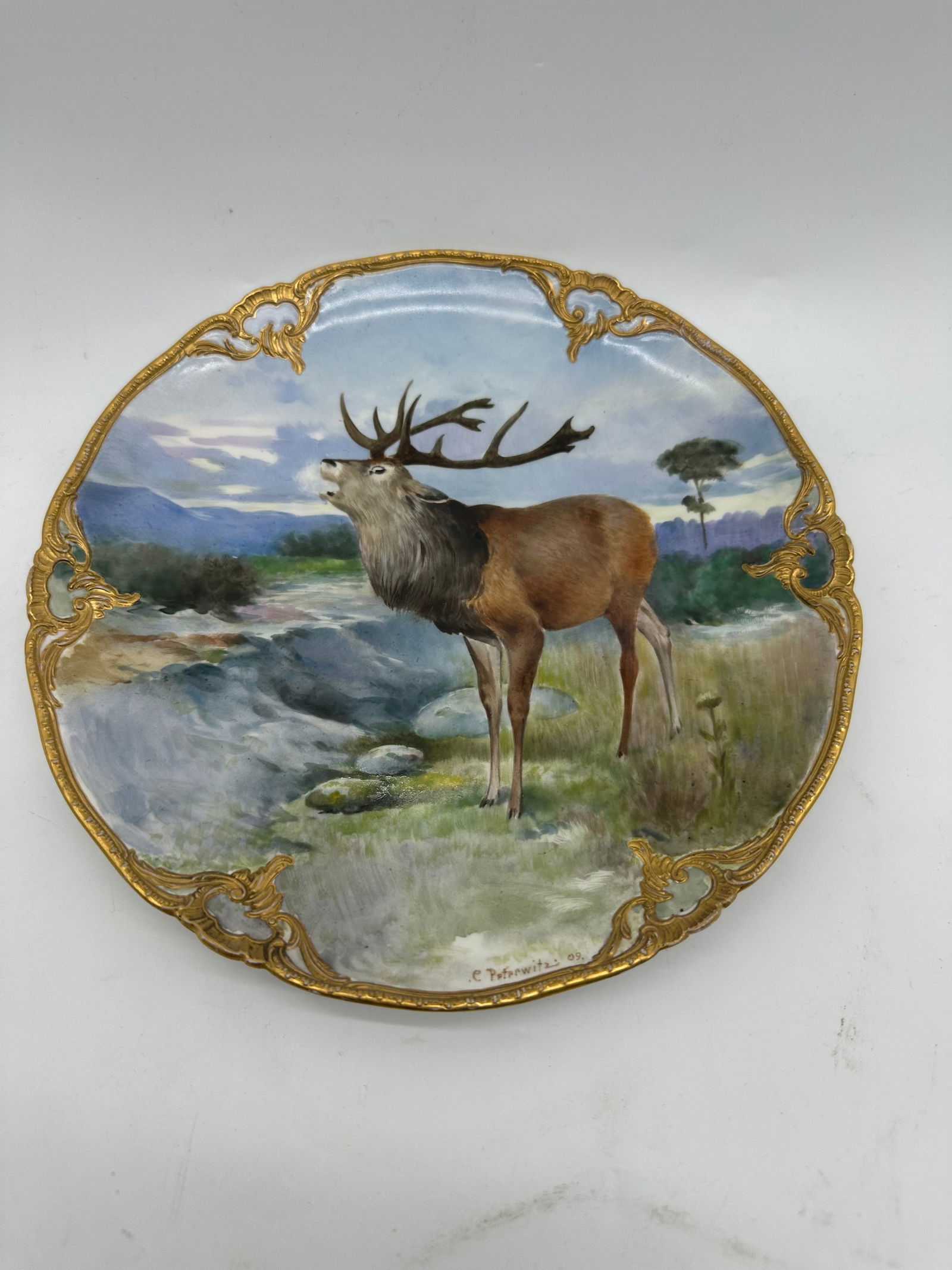 Antique KPM plate hand painted scene deer: KPM Berlin, year letter for 1912, 1st choice, red imperial apple mark, soft painting with flowers, verso marked, rim with rocaille in relief, mat gilded, 8 3/4"Excellent condition, no chips or cracks.