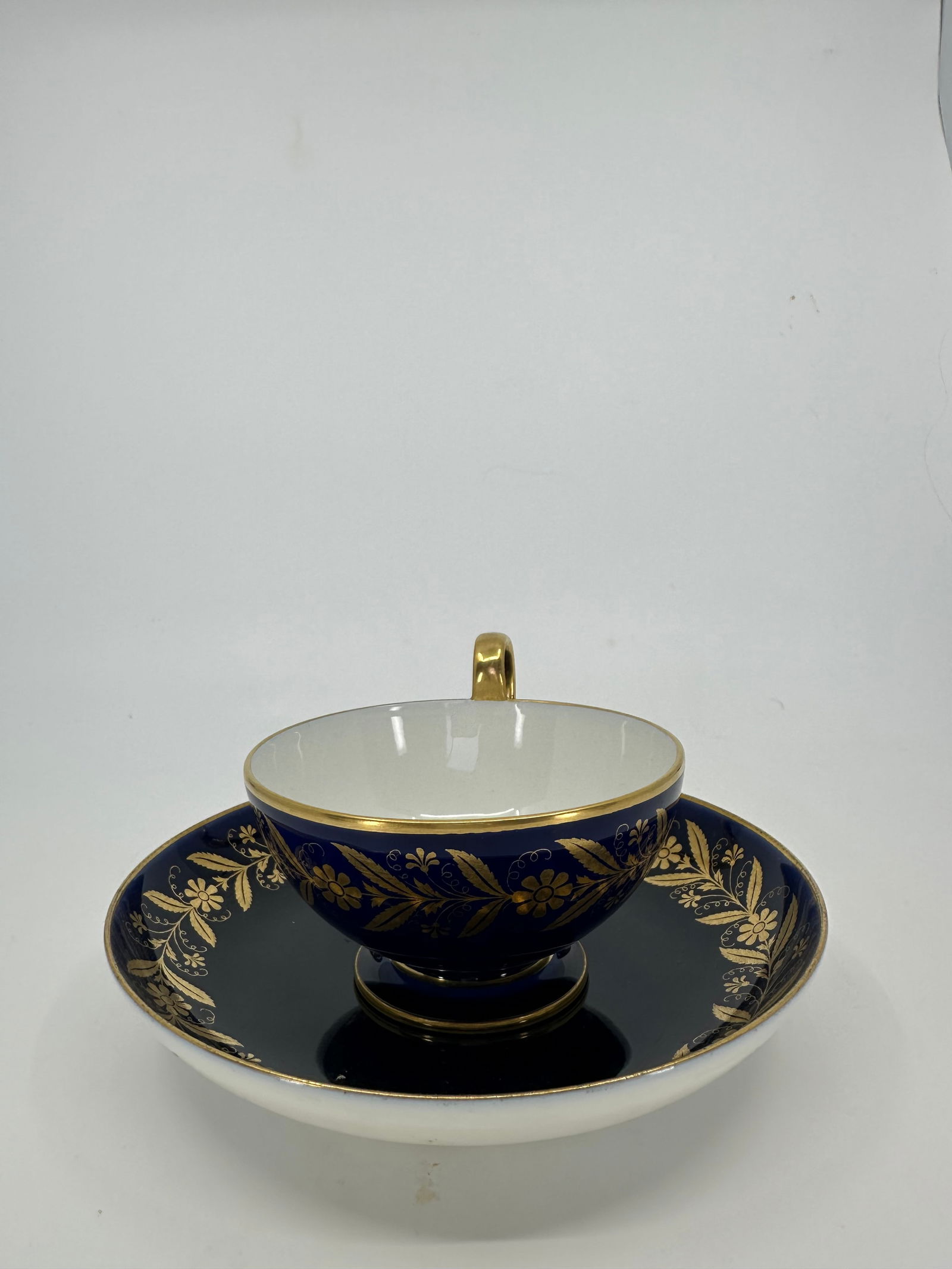 Antique sevres porcelain cup and saucer: DescriptionTea cup and saucer, Sevres, Napoleon mark . 1860, volute handle ending in a palmette, ornamental gilding on cobalt background, h. 5,5 cm diameter 10 cm saucer 15 cm. Condition Report. Excel