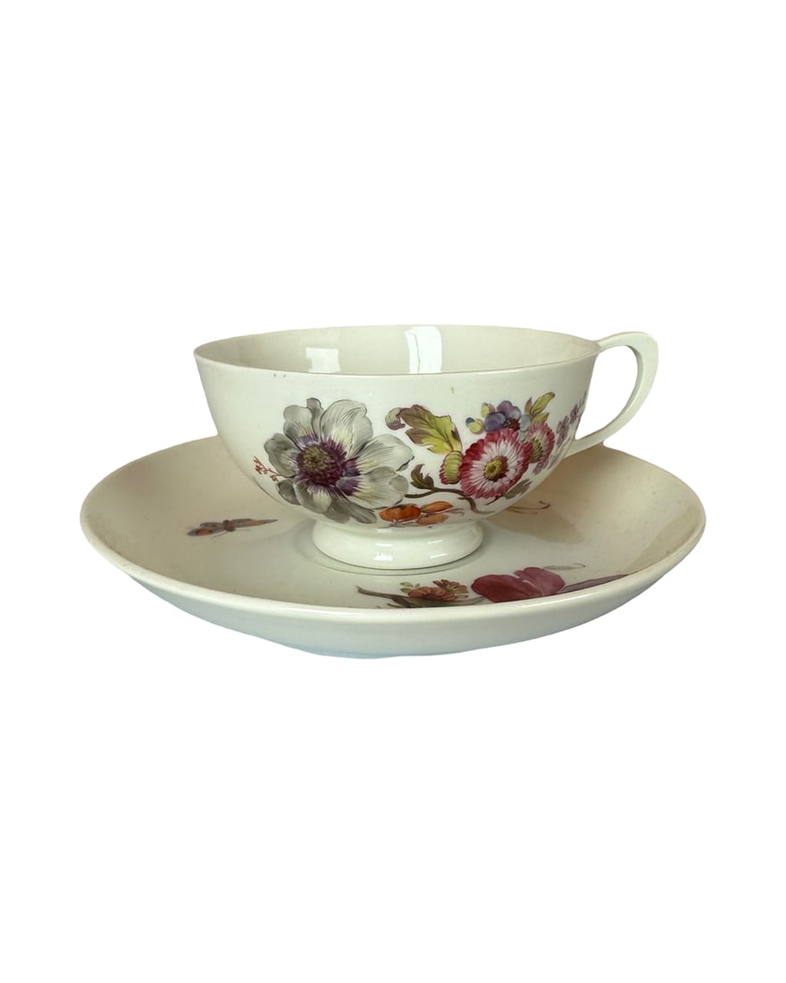 Antique KPM Berlin Hand Painted KPM Floral Butterfly & Tea Cup & Saucer: Nice porcelain tea cup and saucer with relief molded basketweave border. Decorated with hand painted flowers in pink, purple, orange and yellow and a small butterfly on the saucer and a small butterfl