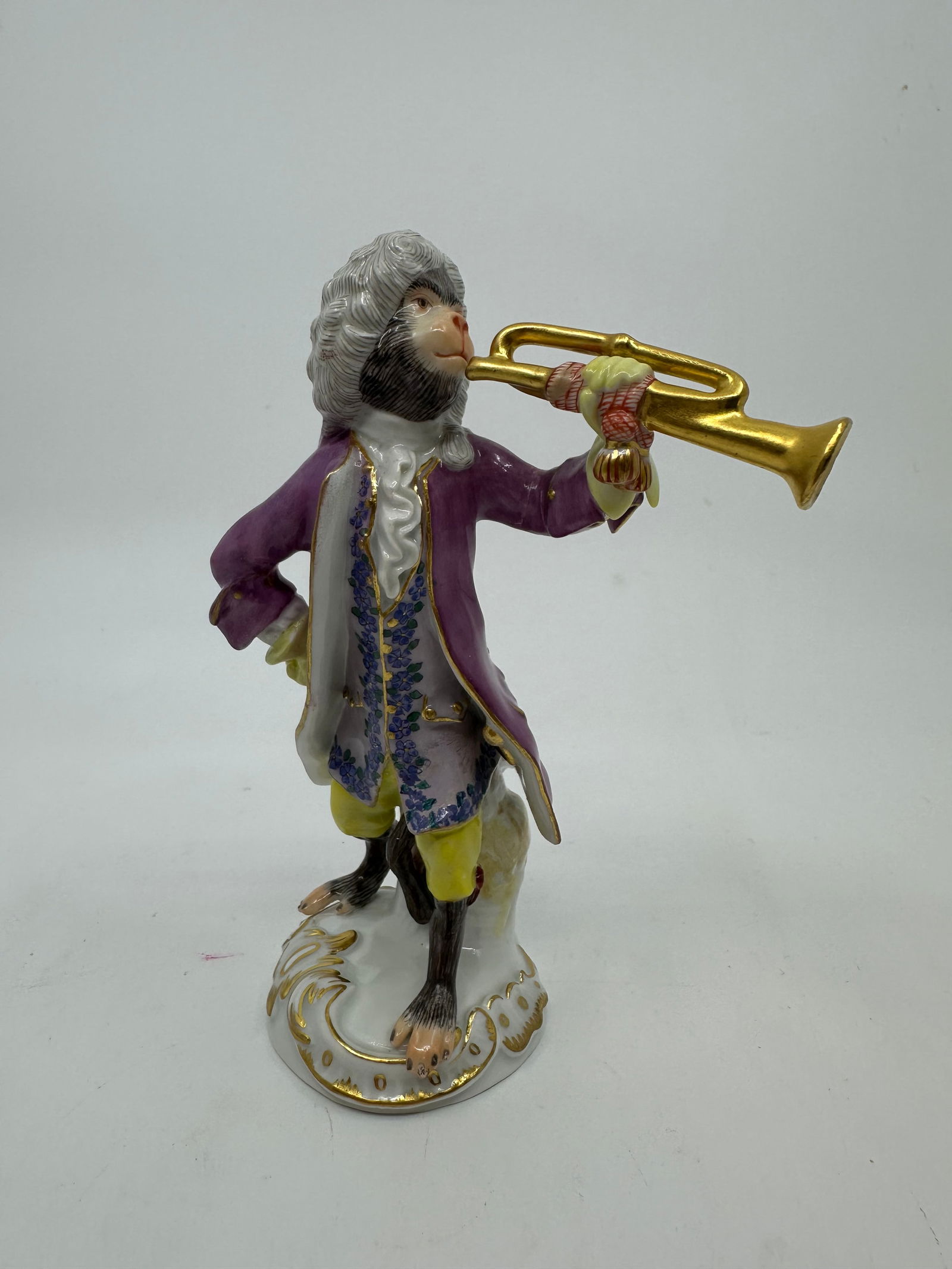 Meissen porcelain monkey band figure: Meissen monkey band member playing a trumpet.Properly marked with Meissen crossed swords.Height 5 1/4 inches.