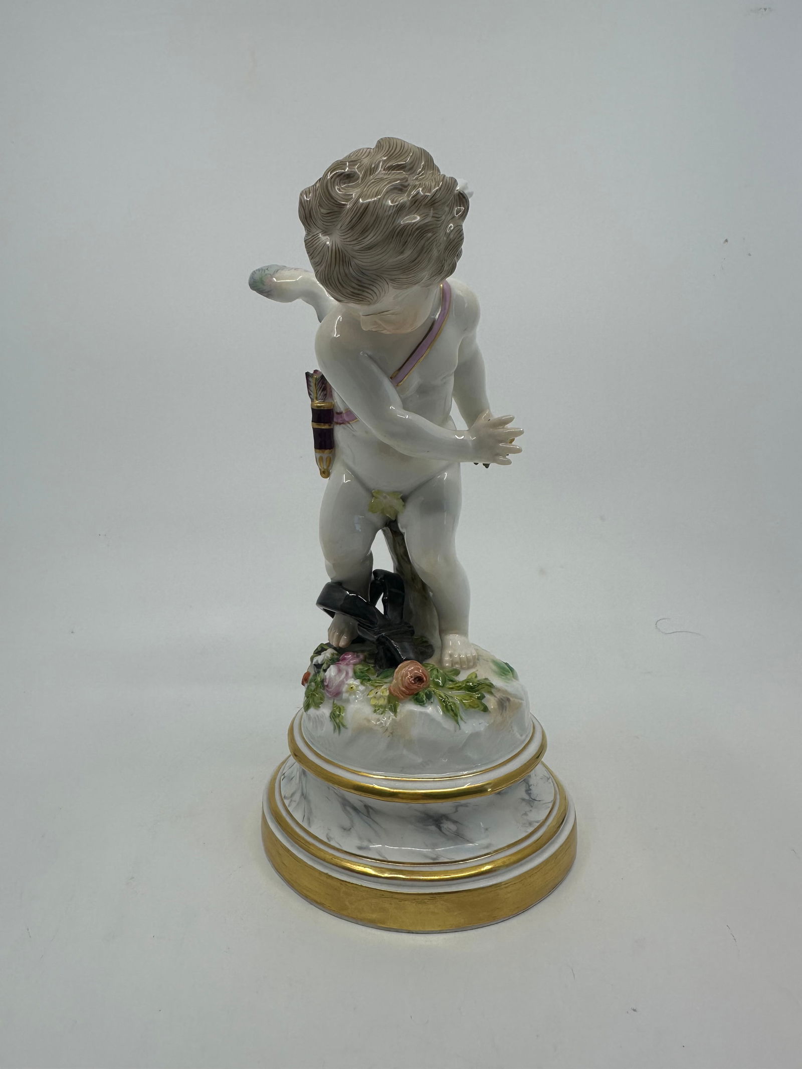 Antique Meissen Cupid Caught In A Trap: DescriptionMeissen figure of cupid caught in trap from the series of 27 cupids first modelled by Heinrich Schwabe 1878.Circa 1890.Model L120.Height 19cm ? Diameter 9.5cmBlue Crossed SwordsConditionExc