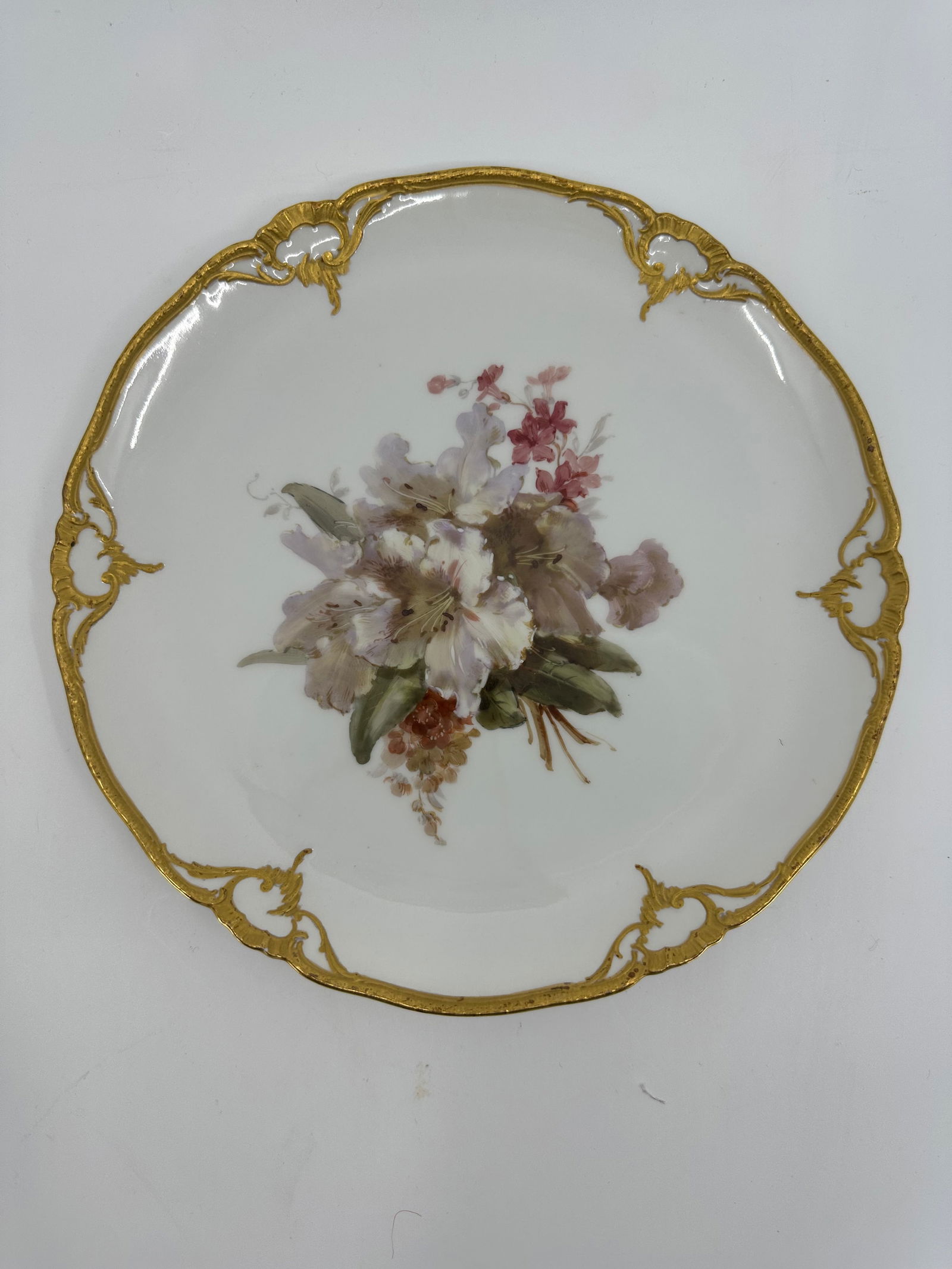 Antique KPM porcelain plate of flowers: Flower plate, KPM Berlin, year letter for 1912, 1st choice, red imperial apple mark, soft painting with flowers, verso marked, rim with rocaille in relief, mat gilded, 8 3/4"Excellent condition, no ch