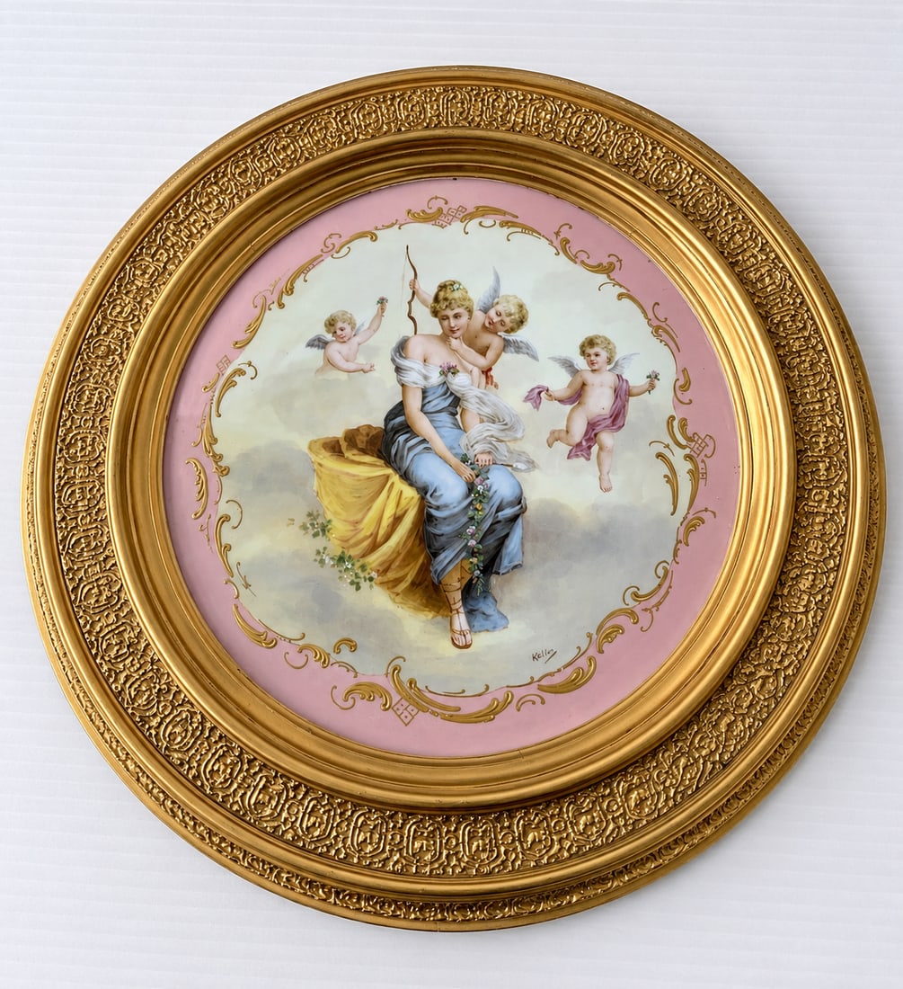 Antique Royal Vienna Porcelain Portrait Hand Painted Charger: ANTIQUE ROYAL VIENNA HAND PAINTED PORTRAIT PLATE Late 19th Century, tilted and impressed maker's markFinely hand painted scene depicts a female surrounded by cherubs. Pink and gilt borders.Diameter: 1