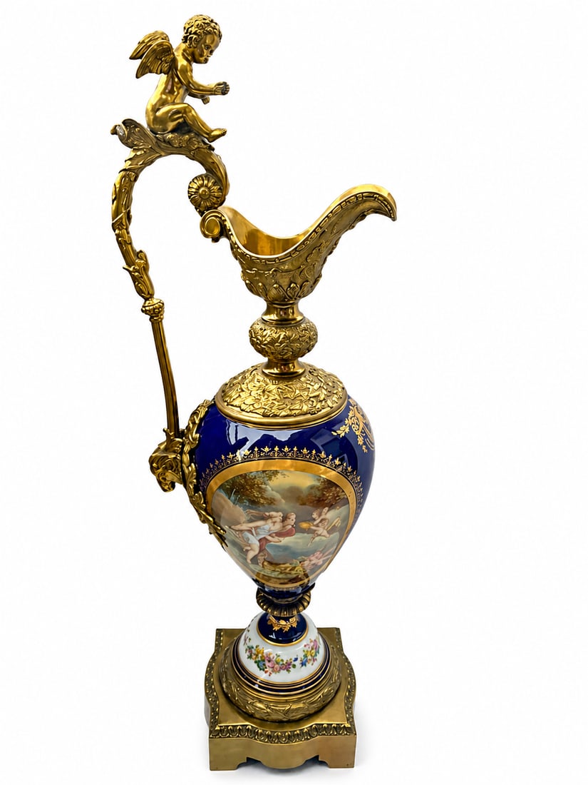 Monumental Antique Sevres Hand Painted Porcelain and Bronze Ewer: ANTIQUE SEVRES ORMOLU-MOUNTED SEVRES COBALT GROUND EWER LATE 19TH Century,Of baluster form with an upright scroll handle, the spout cast with acanthus, the shoulder with stiff-leaf tips, painted front