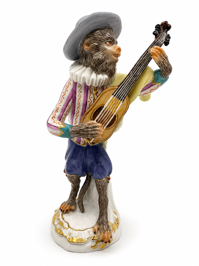 Meissen porcelain monkey band figure: Meissen porcelain monkey band figure. 20th century. scroll molded base with gilt edges. Blue crossed swords mark under glaze on base. Guitarist: 5.5" x 2 3/4".Condition Excellent condition, no chips o