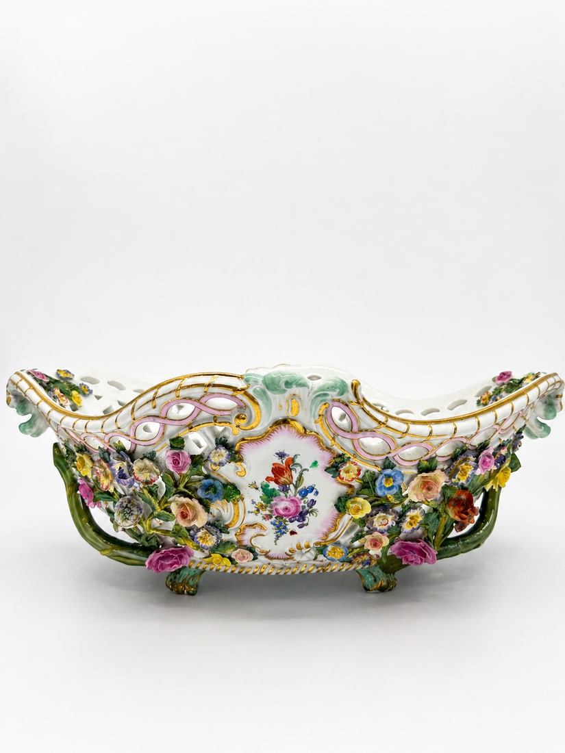 A MEISSEN FLOWER-ENCRUSTED BASKET: A MEISSEN FLOWER-ENCRUSTED BASKETCIRCA 1870, BLUE CROSSED SWORDS MARKS AND INCISED E152Of lozenge form, the pierced sides applied with trailing flowers and leaves, framing two rocaille-moulded cartouc