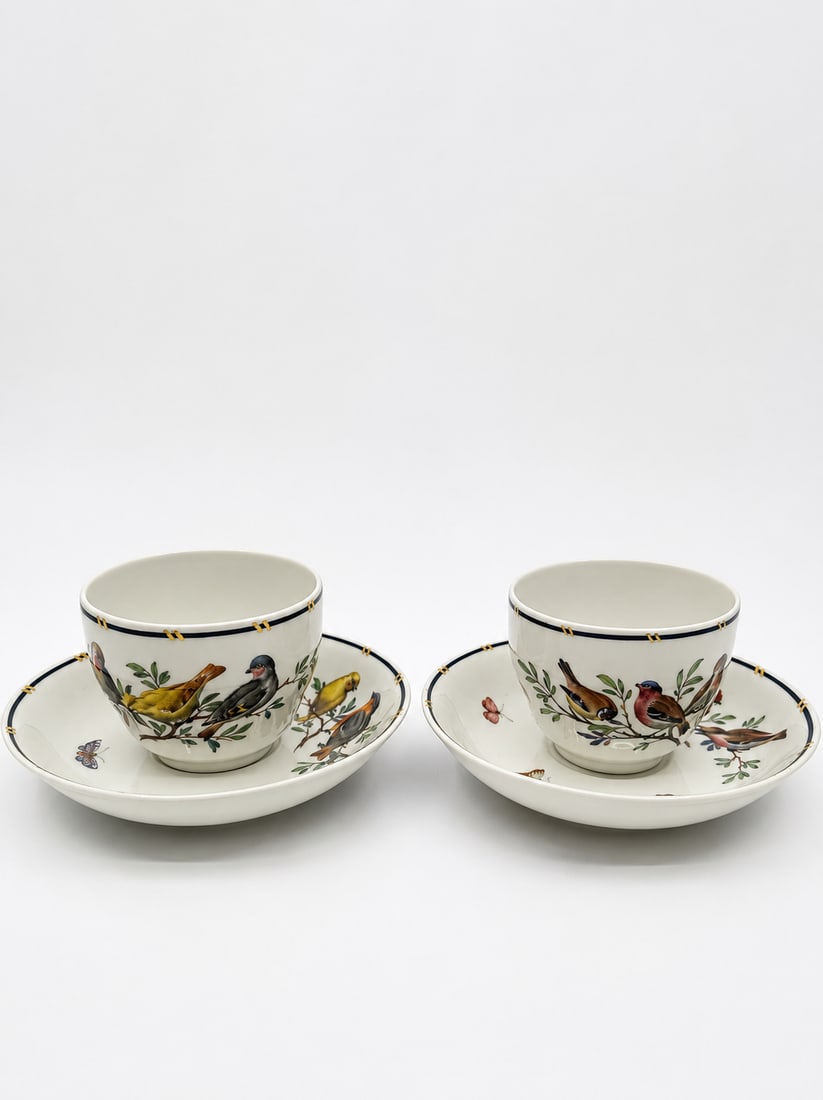 Pair KPM Berlin Porcelain Birds and Butterflies Coffee Cups and Saucers c. 1914: This auction is for a pair of hand-painted KPM Berlin Porcelain coffee cups and saucers decorated with birds and butterflies. Each piece is unique, with different birds. They are marked KPM with a sce