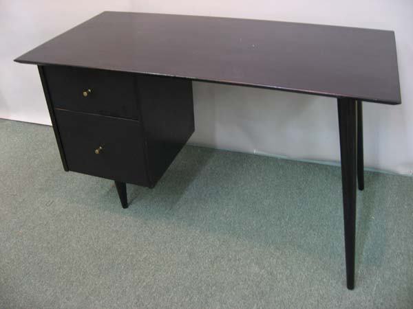 Paul McCobb Planner Group two-drawer desk: Paul McCobb Planner Group two-drawer desk ebonized wood with asymmetric tapering legs and brass fittings. Made by Winchendon. Branded mark on drawer. 29.5"H, 48" W, 24" D.