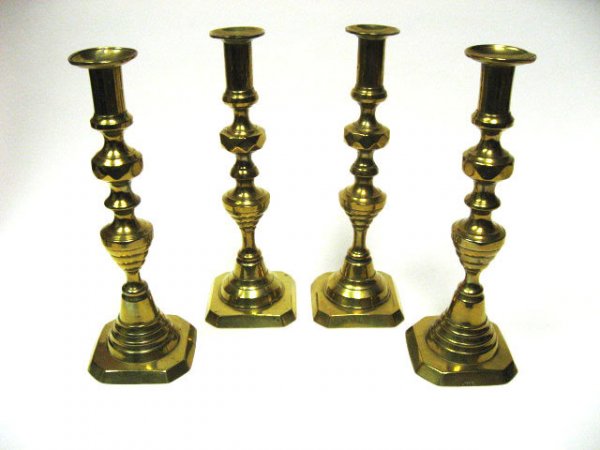 Four Early Brass Candlesticks,